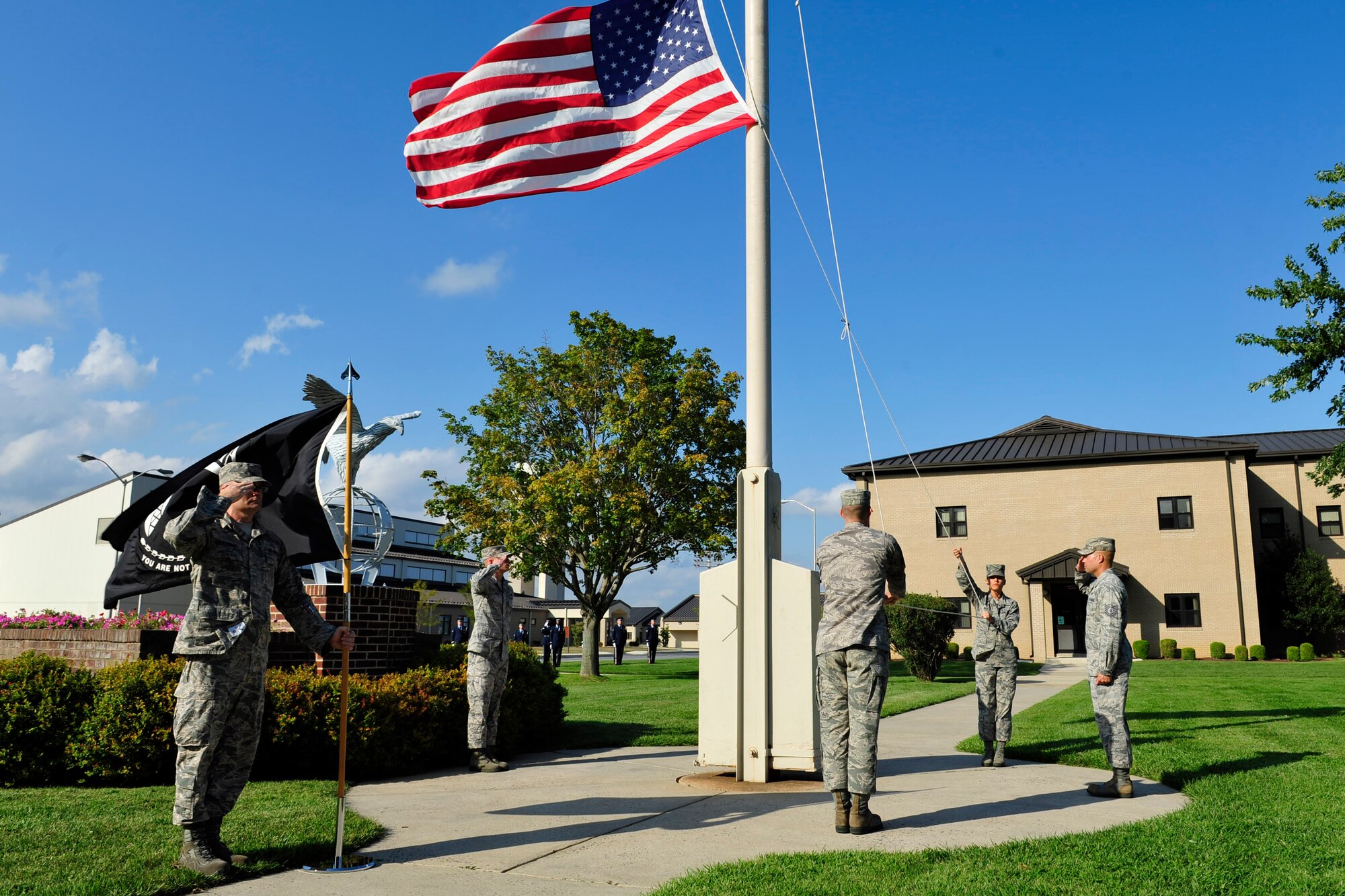 Members of the Dover Air Force Base Honor Guard lower the American flag during the POW/MIA Remembrance Day retreat ceremony Sept. 19, 2014 at Dover Air Force Base, Del. The retreat ceremony closed off the day’s events. (U.S. Air Force photo/Staff Sgt. Elizabeth Morris)