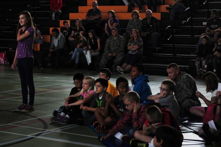Robin Dudley, seventh grade student at Alconbury Middle School and daughter of Heather Dudley, 423rd Air Base Group school liaison officer, asks NASA astronaut and U.S. Air Force Col. Michael Hopkins about the education and training path that helped travel into space during a video teleconference inside the school gymnasium at RAF Alconbury, United Kingdom, Sept. 23, 2014. Hopkins answered questions from students about life in space, the future of NASA and even possibly meeting extraterrestrials. (U.S. Air Force photo by Staff Sgt. Jarad A. Denton/Released) 