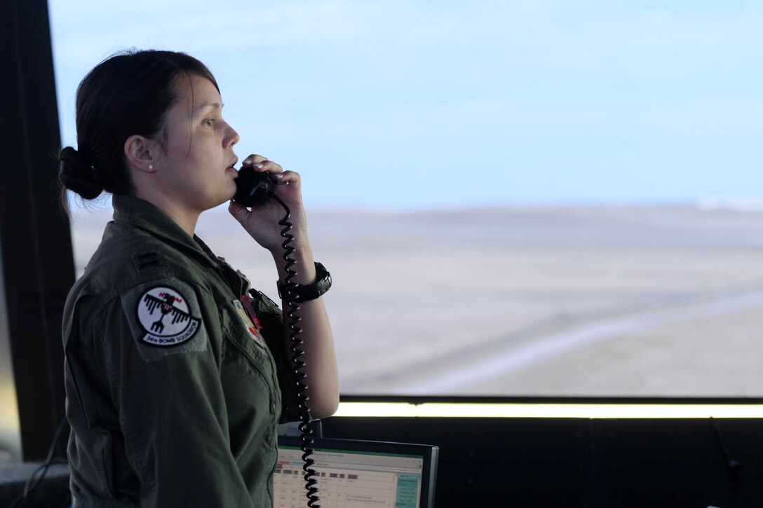 Capt. Amanda Hobbs, 34th Bomb Squadron instructor pilot and supervisor of flying in Ellsworth’s control tower speaks with ground crews at Ellsworth Air Force Base, S.D., Sept. 22, 2014. The supervisor of flying acts as a liaison between pilots and controllers to maintain two-way communication that is critical for all missions to be carried out safely and effectively. (U.S. Air Force photo by Airman 1st Class Rebecca Imwalle/ Released)