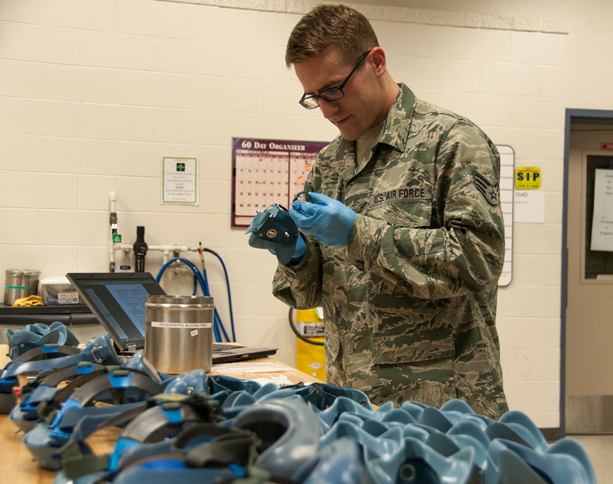 Senior Airman Kenneth Mendenhall, 176th Operation Support Squadron aircrew flight equipment journeyman, inspects a flight mask on Joint Base Elmendorf-Richardson, Alaska, Sept. 15, 2014. Mendenhall is part of an elite group of Airmen who check flight equipment for any inconsistencies or defects that may inhibit its use during real world missions. (U.S. Air Force photo/Airman 1st Class Kyle Johnson)