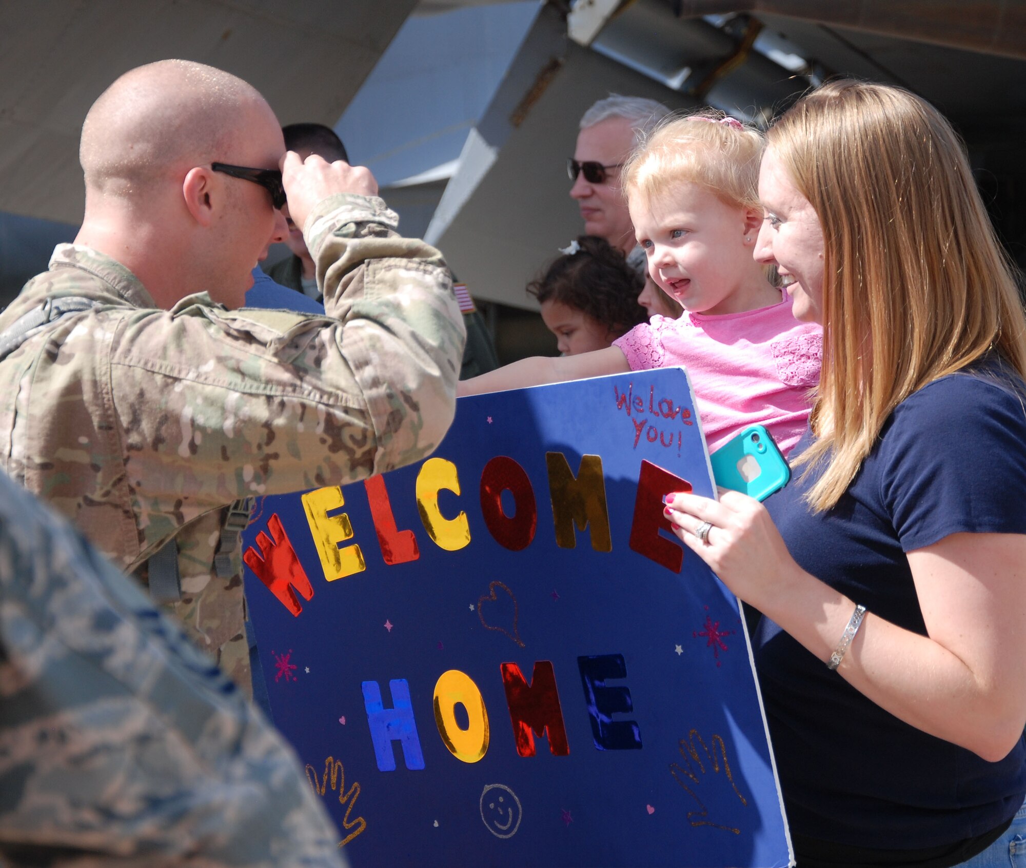 Tech Sgt. Ryan McPartland, 931st Maintenance Squadron crew chief, greets his spouse, Amanda, and his daughter, Kyla, at McConnell Air Force Base, Kan., Sept. 22, 2014.  McPartland deployed with 15 other Reservists from the 931st Air Refueling Group.  (U.S. Air Force photos by Staff Sgt. Abigail Klein)
 
