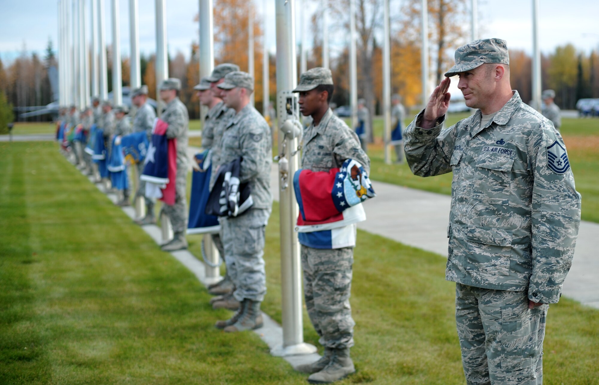 U.S. Air Force Master Sgt. Bryan Hinton, the Air Force Sergeants Association Chapter 1474 president and POW/MIA event coordinator, salutes during a POW/MIA memorial Sept. 19, 2014, at Eielson Air Force Base, Alaska. The ceremony concluded a 24-hour vigil run dedicated to American prisoners of war and those missing in action. (U.S. Air Force photo by Staff Sgt. Jim Araos/Released)