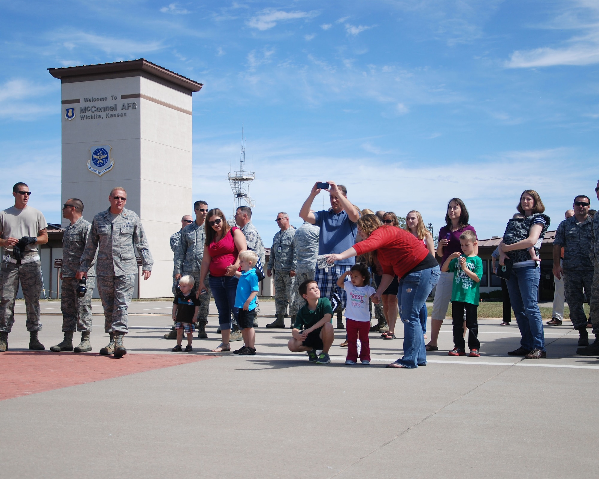 Family members and leaders of the 931st Air Refueling Group gather before greeting returning Airmen at McConnell Air Force Base, Kan., Sept. 22, 2014. Fifteen members of the 931st ARG returned after a 120-day deployment to Southwest Asia.  (U.S. Air Force photo by Staff Sgt. Abigail Klein)