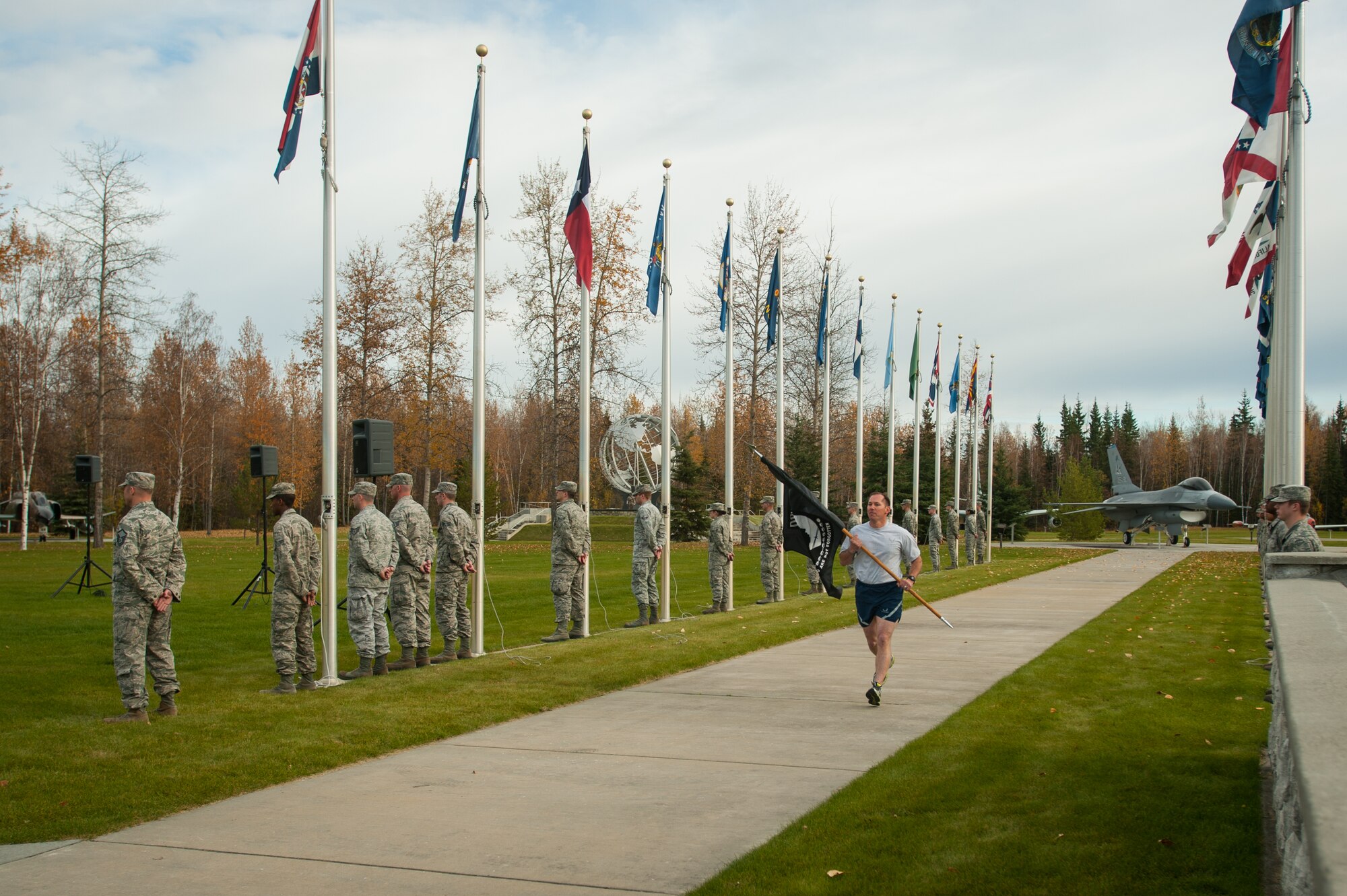 U.S. Air Force Master Sgt. Jerome Vahalik, 354th Security Forces Squadron, runs the last leg of the POW/MIA vigil run before the POW/MIA Recognition Day Ceremony at Eielson Air Force Base, Alaska, Sept. 19, 2014.  The third Friday of September each year is observed across the United States as National POW/MIA Recognition Day to honor prisoners of war and the missing as well as their families and highlights the government's commitment to account for them. (U.S. Air Force photo by Tech. Sgt. Joseph Swafford/Released)
