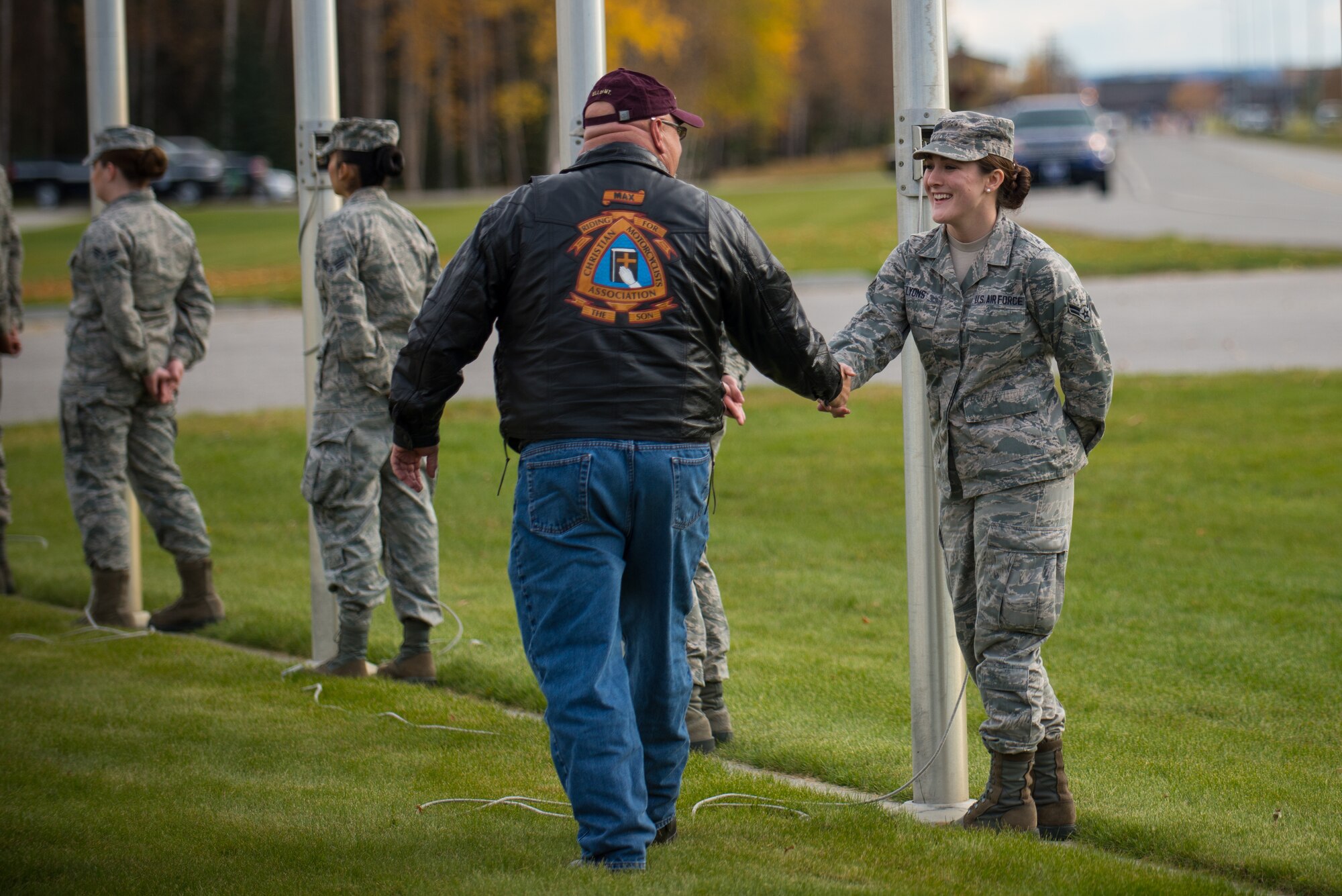 U.S. Air Force Airman 1st Class Alicia Lyons with the 354th Force Support Squadron greets a member of the Christian Motorcyclists Association before the National POW/MIA Recognition Day Ceremony at Eielson Air Force Base, Alaska, Sept. 19, 2014.  The third Friday of September each year is observed across the United States as National POW/MIA Recognition Day to honor prisoners of war and the missing as well as their families and highlights the government's commitment to account for them. (U.S. Air Force photo by Tech. Sgt. Joseph Swafford/Released)