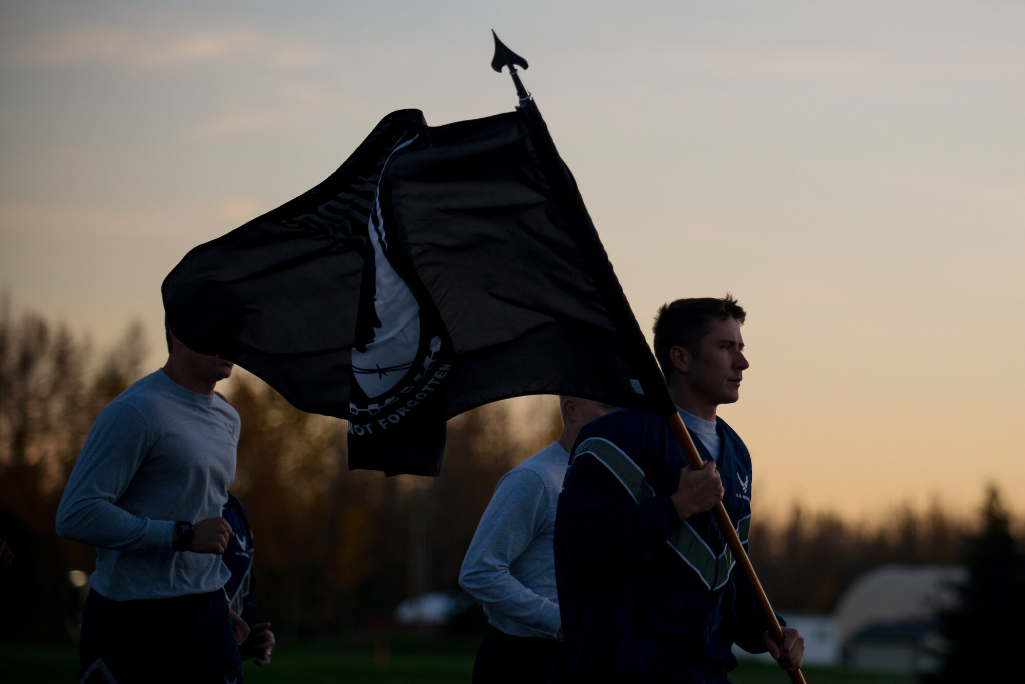 U.S. Airmen assigned to Detachment 1, 3rd Air Operations Support Squadron, participate in a POW/MIA 24-hour vigil run during National POW/MIA Recognition Day at Eielson Air Force Base, Alaska, Sept. 19, 2014.  The third Friday of September each year is observed across the United States as National POW/MIA Recognition Day to honor prisoners of war and the missing as well as their families and highlights the government's commitment to account for them. (U.S. Air Force photo by Tech. Sgt. Joseph Swafford/Released)