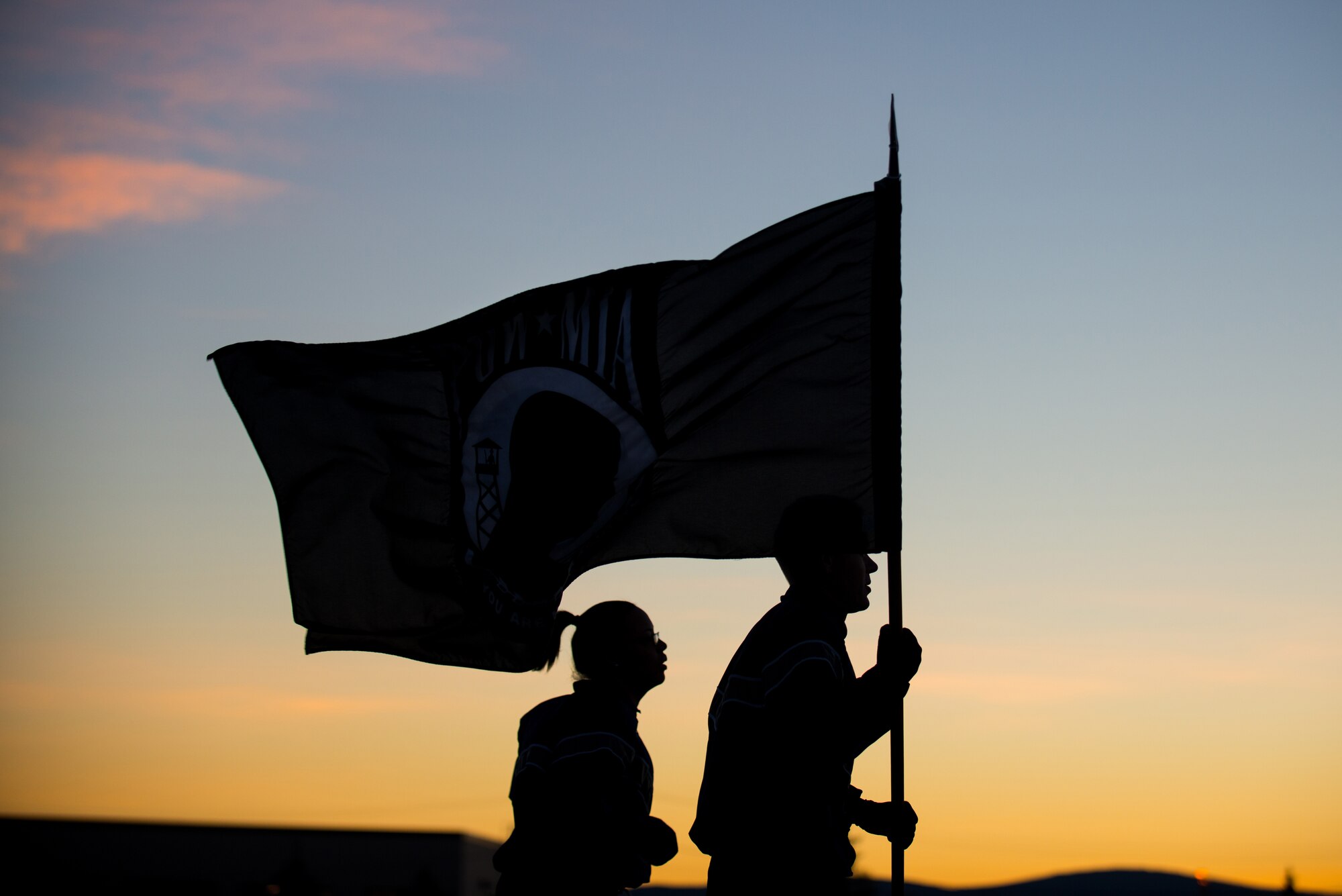 U.S. Air Force Maj. Philip Broyles and  Senior Airman Martina Mizell, both assigned to the 354th Maintenance Squadron, participate in a POW/MIA 24-hour vigil run during National POW/MIA Recognition Day at Eielson Air Force Base, Alaska, Sept. 19, 2014.  The third Friday of September each year is observed across the United States as National POW/MIA Recognition Day to honor prisoners of war and the missing as well as their families and highlights the government's commitment to account for them. (U.S. Air Force photo by Tech. Sgt. Joseph Swafford/Released)