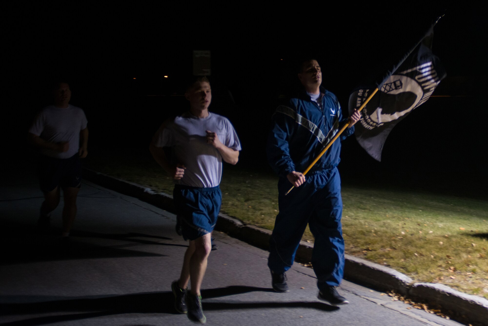 U.S. Airmen participate in a POW/MIA 24-hour vigil run during National POW/MIA Recognition Day at Eielson Air Force Base, Alaska, Sept. 18, 2014.  The third Friday of September each year is observed across the United States as National POW/MIA Recognition Day to honor prisoners of war and the missing as well as their families and highlights the government's commitment to account for them. (U.S. Air Force photo by Tech. Sgt. Joseph Swafford/Released)
