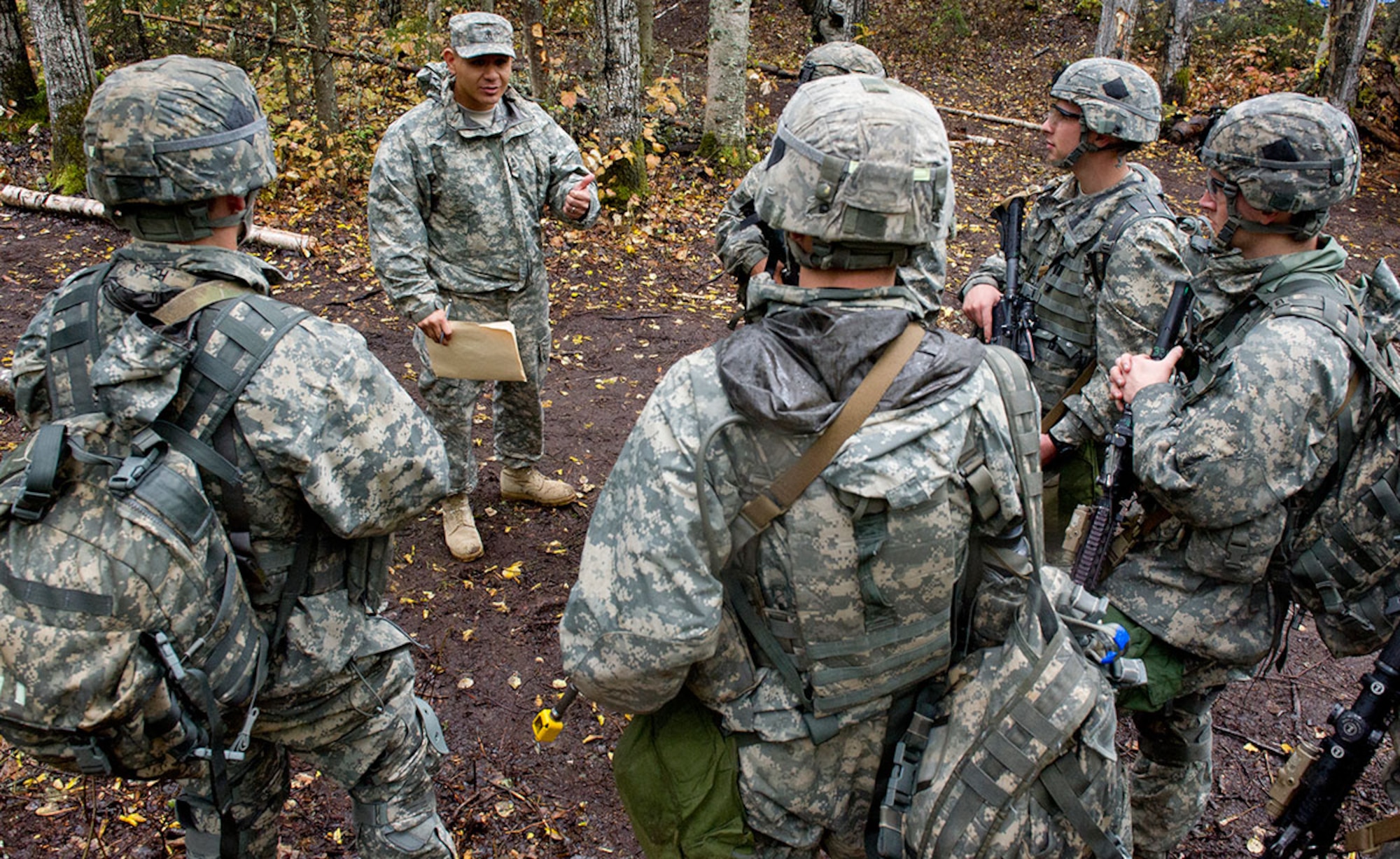 Army 1st Sgt. Nicholas Rembula, a native of Dallas, Texas, assigned to Charlie Company, 1st Battalion (Airborne), 501st Infantry Regiment, 4th Infantry Brigade Combat Team (Airborne), 25th Infantry Division, U.S. Army Alaska, talks to candidates on an Expert Infantryman Badge qualification lane on Joint Base Elmendorf-Richardson, Wednesday, Sept. 10, 2014. The Expert Infantryman Badge was approved by the Secretary of War on October 7, 1943, and is currently awarded to U.S. Army personnel who hold infantry or special forces military occupational specialties and successfully pass the rigors of the course. (U.S. Air Force photo/Justin Connaher)
