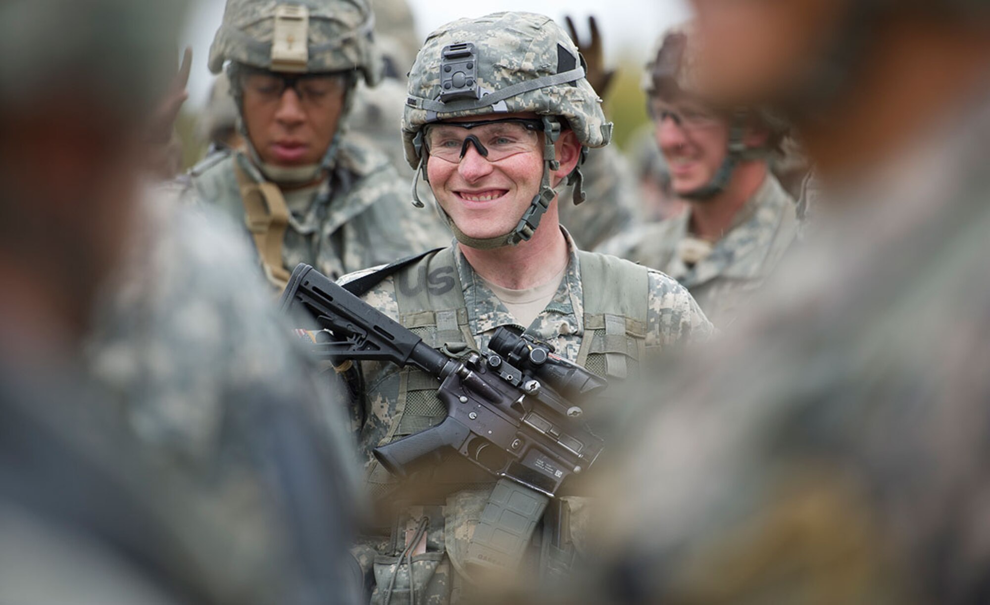 Army Staff Sgt. Justin Barros, a native of Columbia, Conn., assigned to  Alpha Company, 4th Infantry Brigade Combat Team (Airborne), 25th Infantry Division, U.S. Army Alaska, smiles as he awaits instructions on the land navigation course during Expert Infantryman Badge qualification on Joint Base Elmendorf-Richardson, Tuesday, Sept. 9, 2014. The Expert Infantryman Badge was approved by the Secretary of War on October 7, 1943, and is currently awarded to U.S. Army personnel who hold infantry or special forces military occupational specialties and successfully pass the rigors of the course. (U.S. Air Force photo/Justin Connaher)
