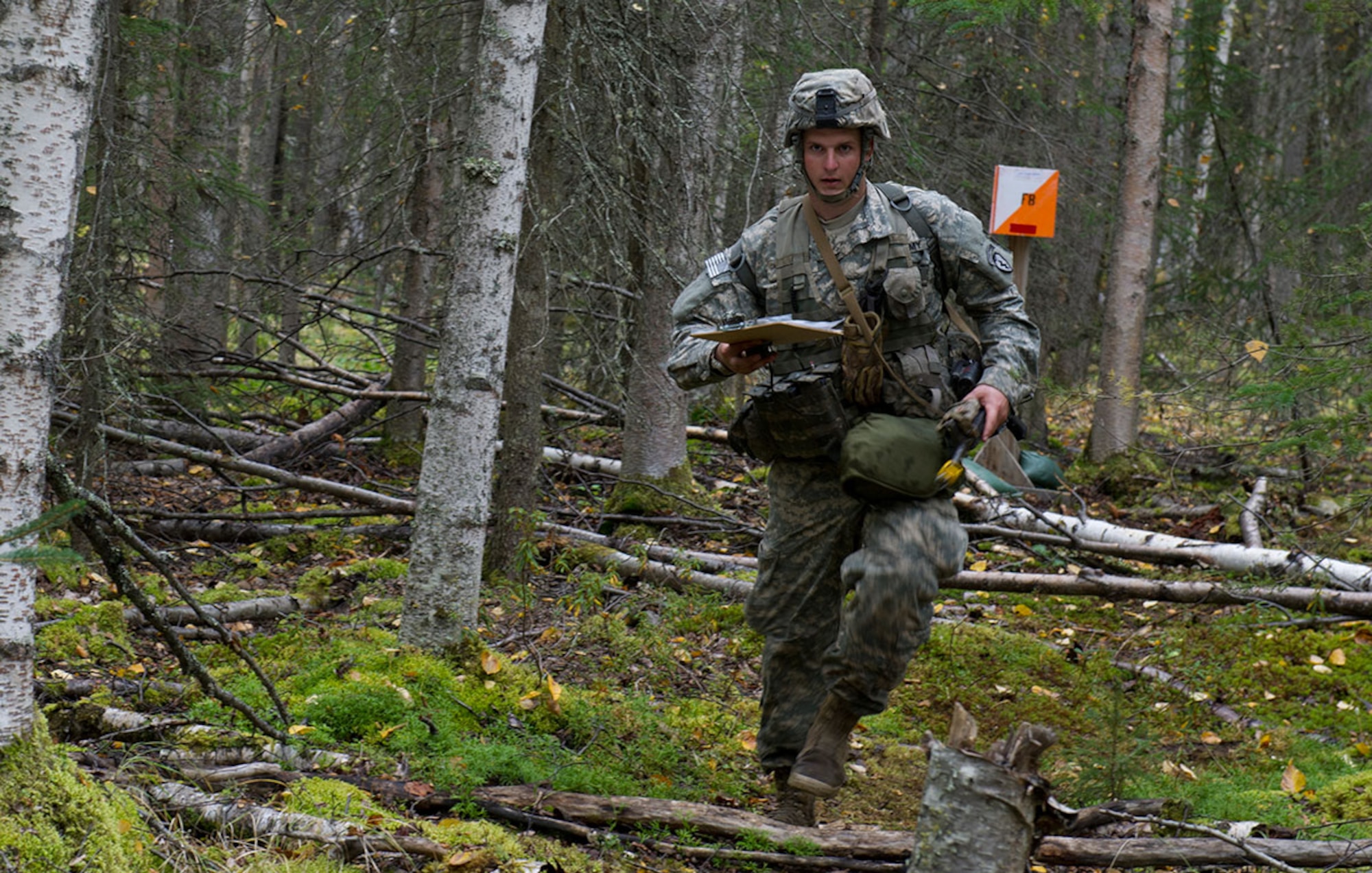Spc. Mattew Ward, a native of Westminster, Md., assigned to Dog Company, 3rd Battalion (Airborne), 509th Infantry Regiment, 4th Infantry Brigade Combat Team (Airborne), 25th Infantry Division, U.S. Army Alaska, runs to his next point on the land navigation course during Expert Infantryman Badge qualification on Joint Base Elmendorf-Richardson, Tuesday, Sept. 9, 2014. The Expert Infantryman Badge was approved by the Secretary of War on October 7, 1943, and is currently awarded to U.S. Army personnel who hold infantry or special forces military occupational specialties and successfully pass the rigors of the course. (U.S. Air Force photo/Justin Connaher)