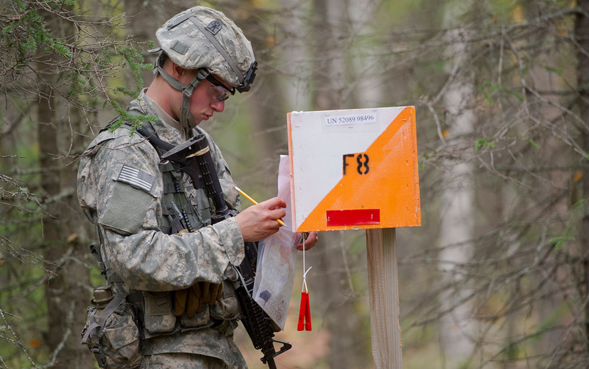 Pvt. Max Fogel, a native of Kansas City, Mo., assigned to Able Company, 3rd Battalion (Airborne), 509th Infantry Regiment, 4th Infantry Brigade Combat Team (Airborne), 25th Infantry Division, U.S. Army Alaska, calculates his next move on the land navigation course during Expert Infantryman Badge qualification on Joint Base Elmendorf-Richardson, Tuesday, Sept. 9, 2014. The Expert Infantryman Badge was approved by the Secretary of War on October 7, 1943, and is currently awarded to U.S. Army personnel who hold infantry or special forces military occupational specialties and successfully pass the rigors of the course. (U.S. Air Force photo/Justin Connaher)