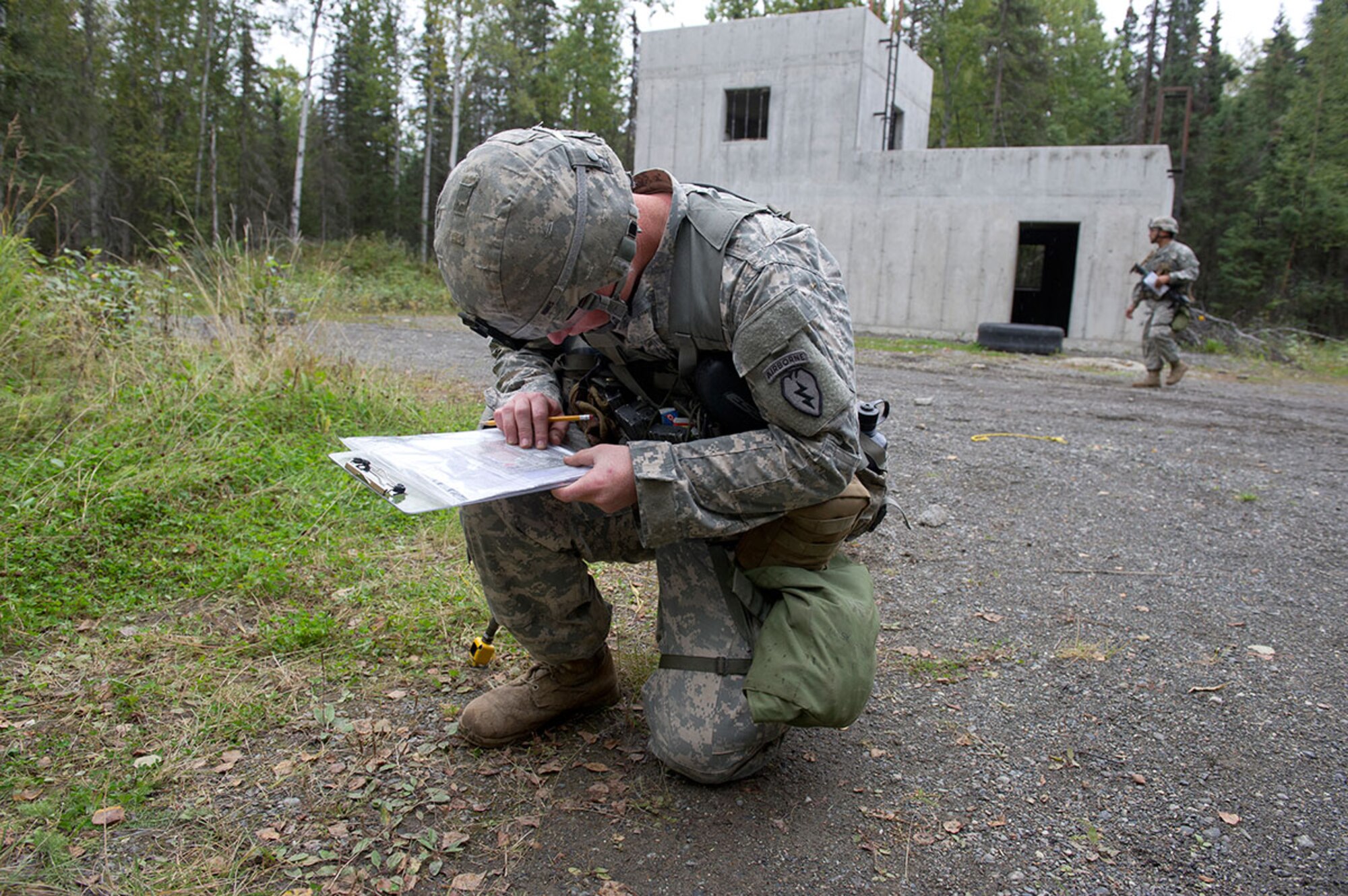 Spc. Nathan Hines, a native of Newberry, Mich., assigned to Baker Company, 3rd Battalion (Airborne), 509th Infantry Regiment, 4th Infantry Brigade Combat Team (Airborne), 25th Infantry Division, U.S. Army Alaska, plots a point on a map on the land navigation course during Expert Infantryman Badge qualification on Joint Base Elmendorf-Richardson, Tuesday, Sept. 9, 2014. The Expert Infantryman Badge was approved by the Secretary of War on October 7, 1943, and is currently awarded to U.S. Army personnel who hold infantry or special forces military occupational specialties and successfully pass the rigors of the course. (U.S. Air Force photo/Justin Connaher)