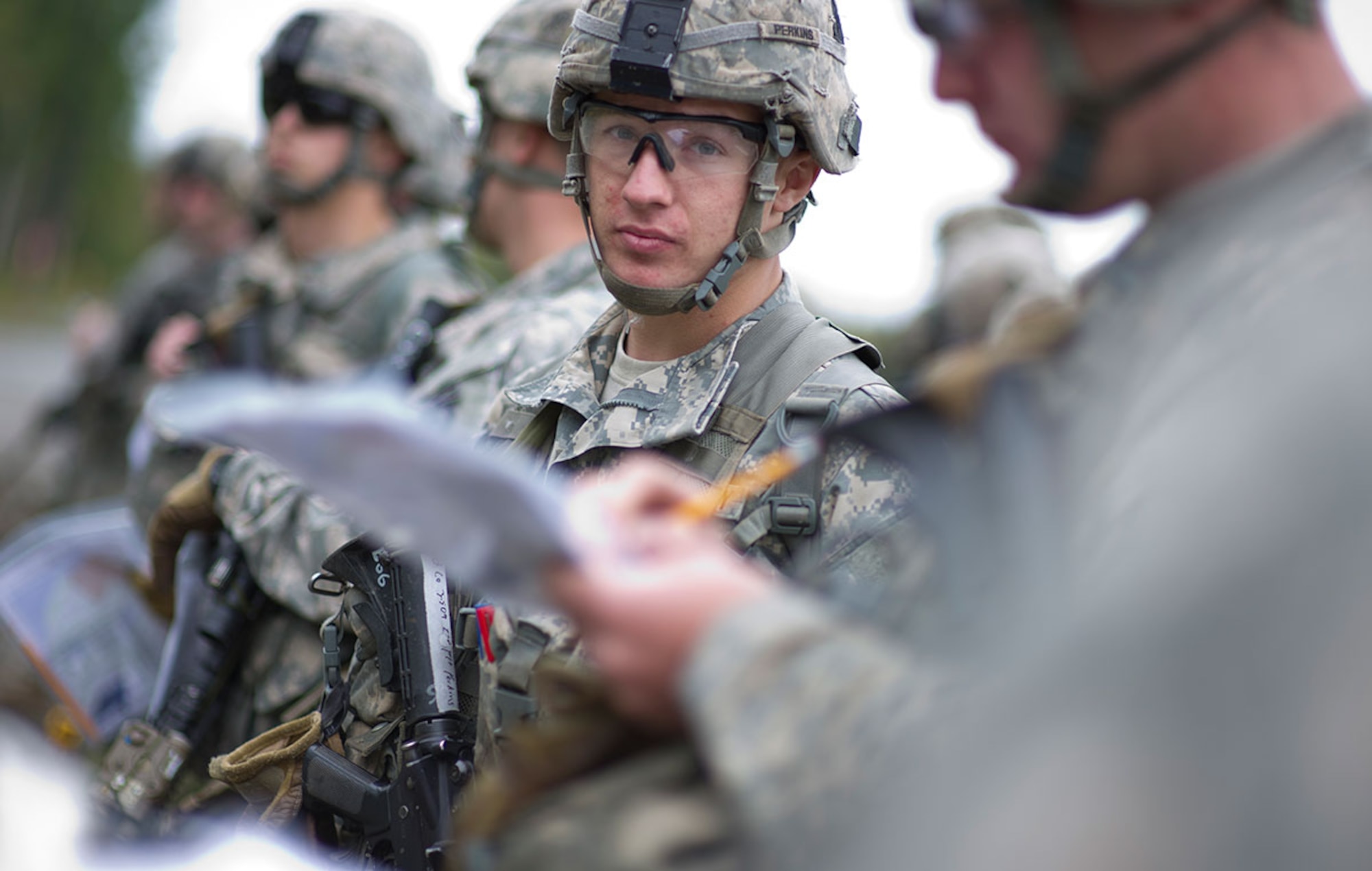 Spc. Walker Perkins, a native of Lee, Maine, assigned to U.S. Army Alaska's 4th Infantry Brigade Combat Team (Airborne), 25th Infantry Division, prepares to test on the land navigation course during Expert Infantryman Badge qualification on Joint Base Elmendorf-Richardson, Tuesday, Sept. 9, 2014. The Expert Infantryman Badge was approved by the Secretary of War on October 7, 1943, and is currently awarded to U.S. Army personnel who hold infantry or special forces military occupational specialties and successfully pass the rigors of the course. (U.S. Air Force photo/Justin Connaher)