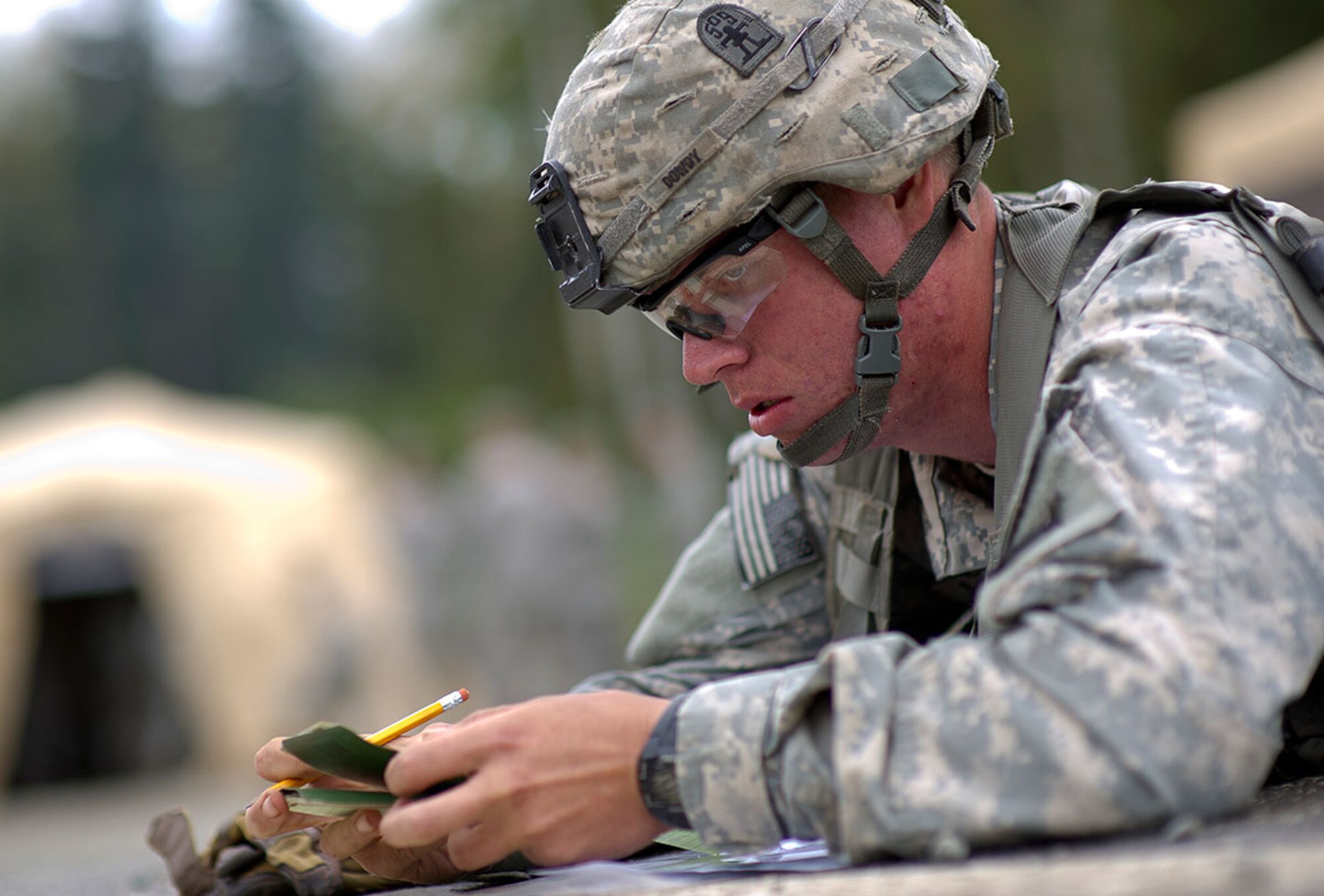 Spc. Dennis Dowey, a Native of Deer Park, Texas, assigned to Baker Company, 3rd Battalion (Airborne), 509th Infantry Regiment, 4th Infantry Brigade Combat Team (Airborne), 25th Infantry Division, U.S. Army Alaska, calculates navigation points as he begins the land navigation course during Expert Infantryman Badge qualification on Joint Base Elmendorf-Richardson, Tuesday, Sept. 9, 2014. The Expert Infantryman Badge was approved by the Secretary of War on October 7, 1943, and is currently awarded to U.S. Army personnel who hold infantry or special forces military occupational specialties and successfully pass the rigors of the course. (U.S. Air Force photo/Justin Connaher)