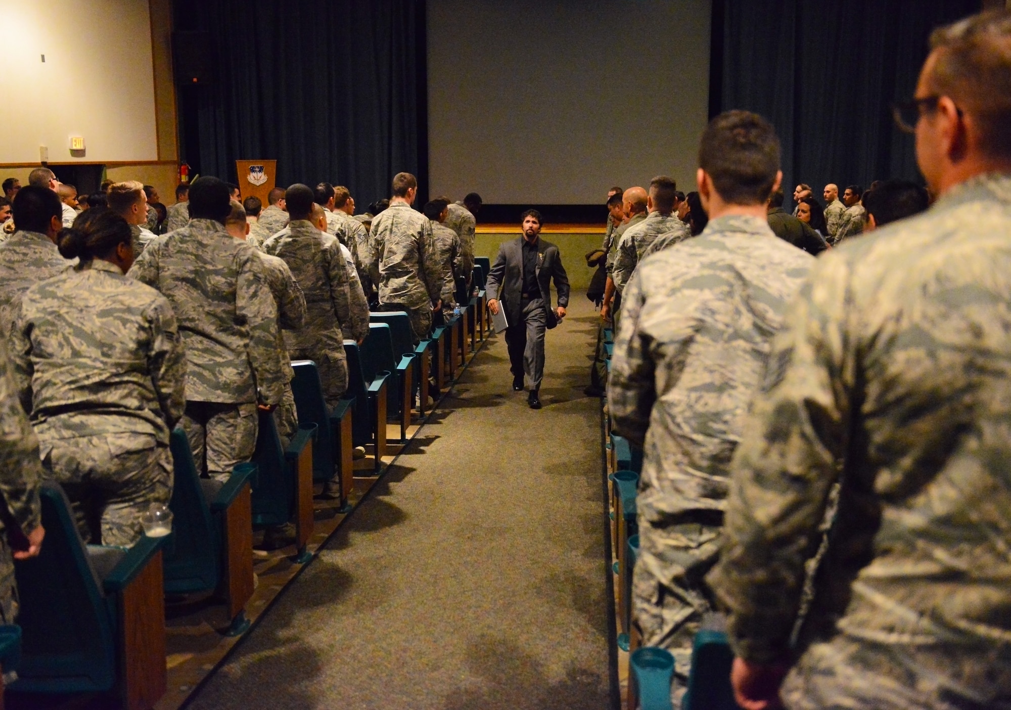 Retired Lt. Jason Redman, U.S. Navy SEAL, exits Malmstrom Air Force Base’s auditorium to a standing ovation after his presentation Sept. 18. While speaking with Airmen, Redman introduced his book and shared stories from the literature, which is based on his experience as a Navy SEAL. (U.S. Air Force photo/Airman 1st Class Collin Schmidt) 