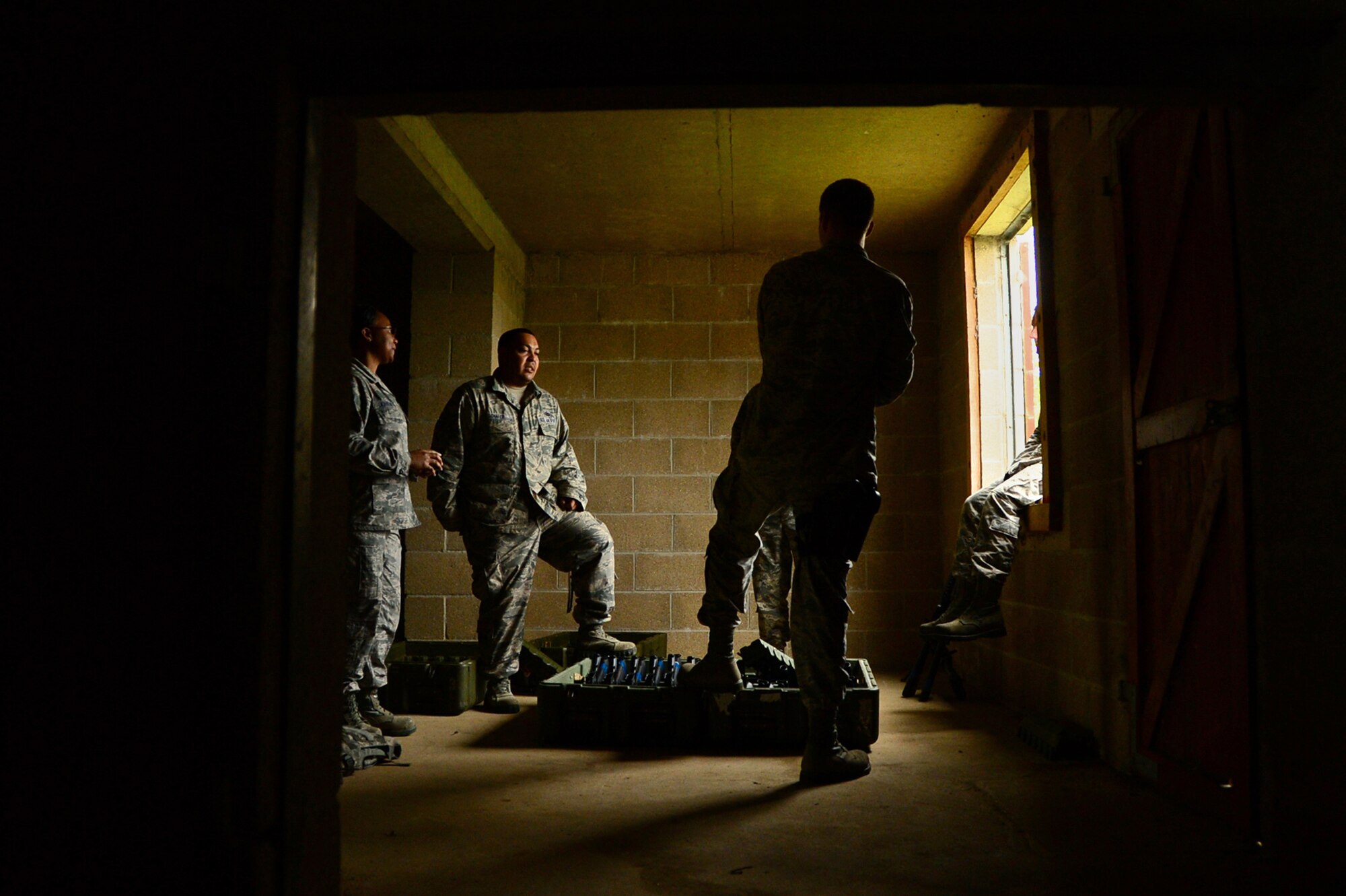 Airmen from the 48th Mission Support Group wait for their next scenario to begin during a force-on-force exercise at Stanford Training Area, England, Sept. 19, 2014. The three-day event consisted of training similar to Combat Skills Training. (U.S. Air Force photo by Airman 1st Class Erin O’Shea/Released)