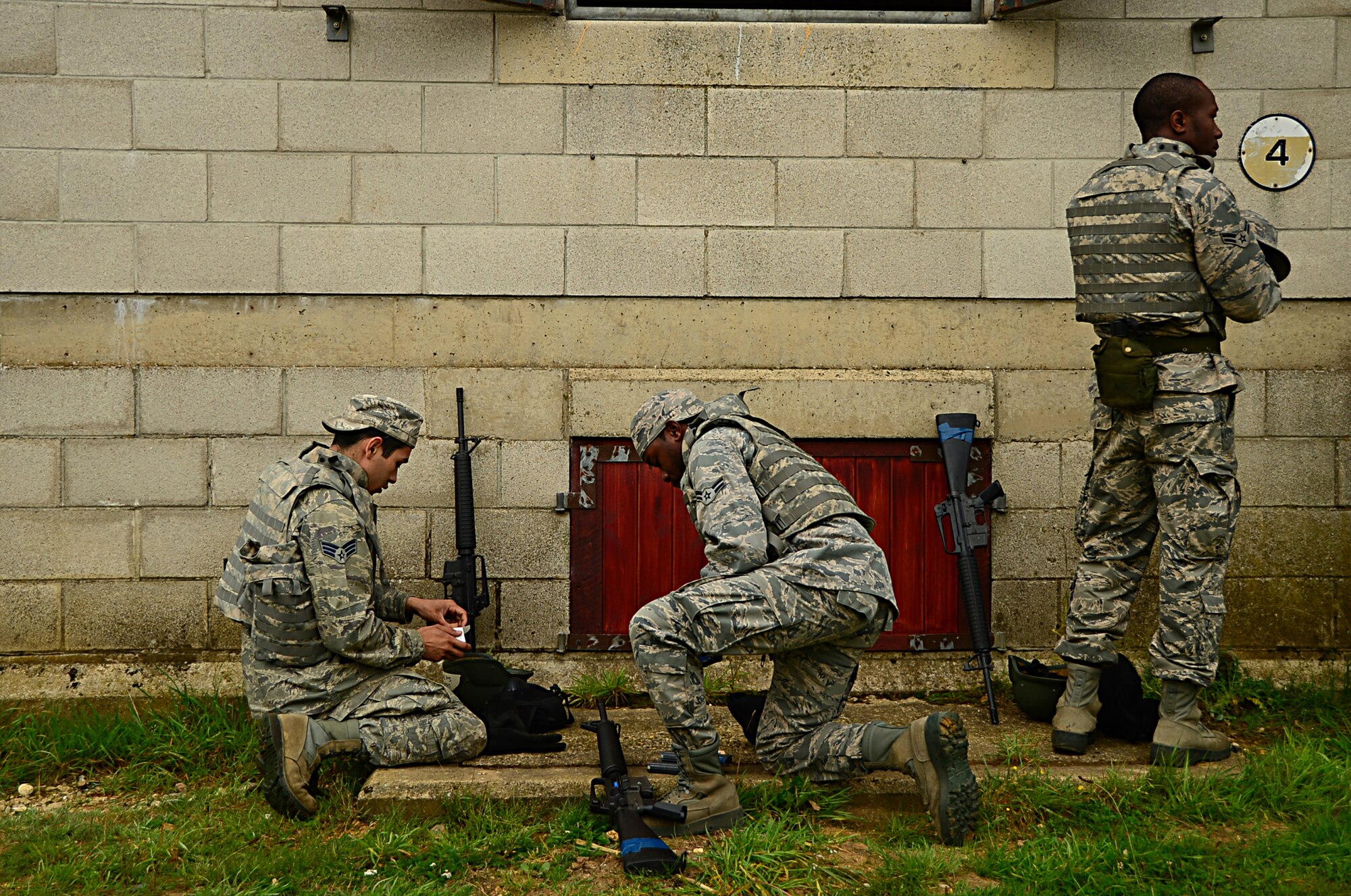 Airmen from the 48th Mission Support Group load their weapons in preparation for a force-on-force exercise at Stanford Training Area, England, Sept. 19, 2014. The three-day training included small unit tactics training to familiarize them with the M16 and M4 rifles and the M9 pistol. (U.S. Air Force photo by Airman 1st Class Erin O’Shea/Released)   