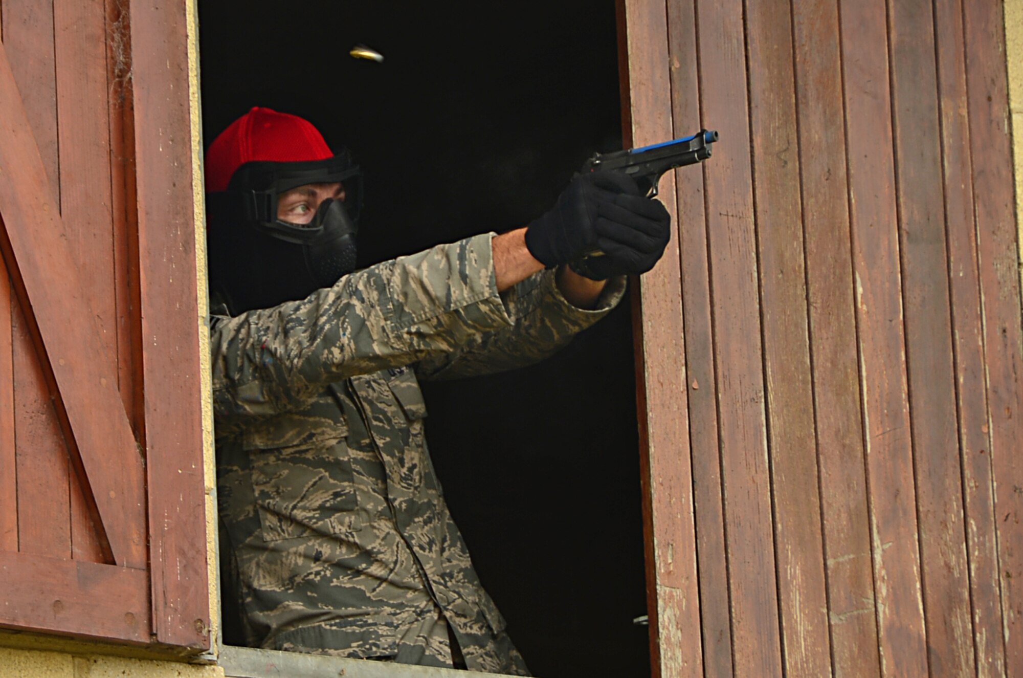 A 48th Security Forces Squadron Combat Arms Training and Maintenance instructor, fires an M9 pistol during a force-on-force exercise at Stanford Training Area, England, Sept. 19, 2014. More than 130 48th MSG Airmen participated in the training exercises and practiced scenarios they could possibly encounter in a deployed environment. (U.S. Air Force photo by Airman 1st Class Erin O’Shea/Released) 