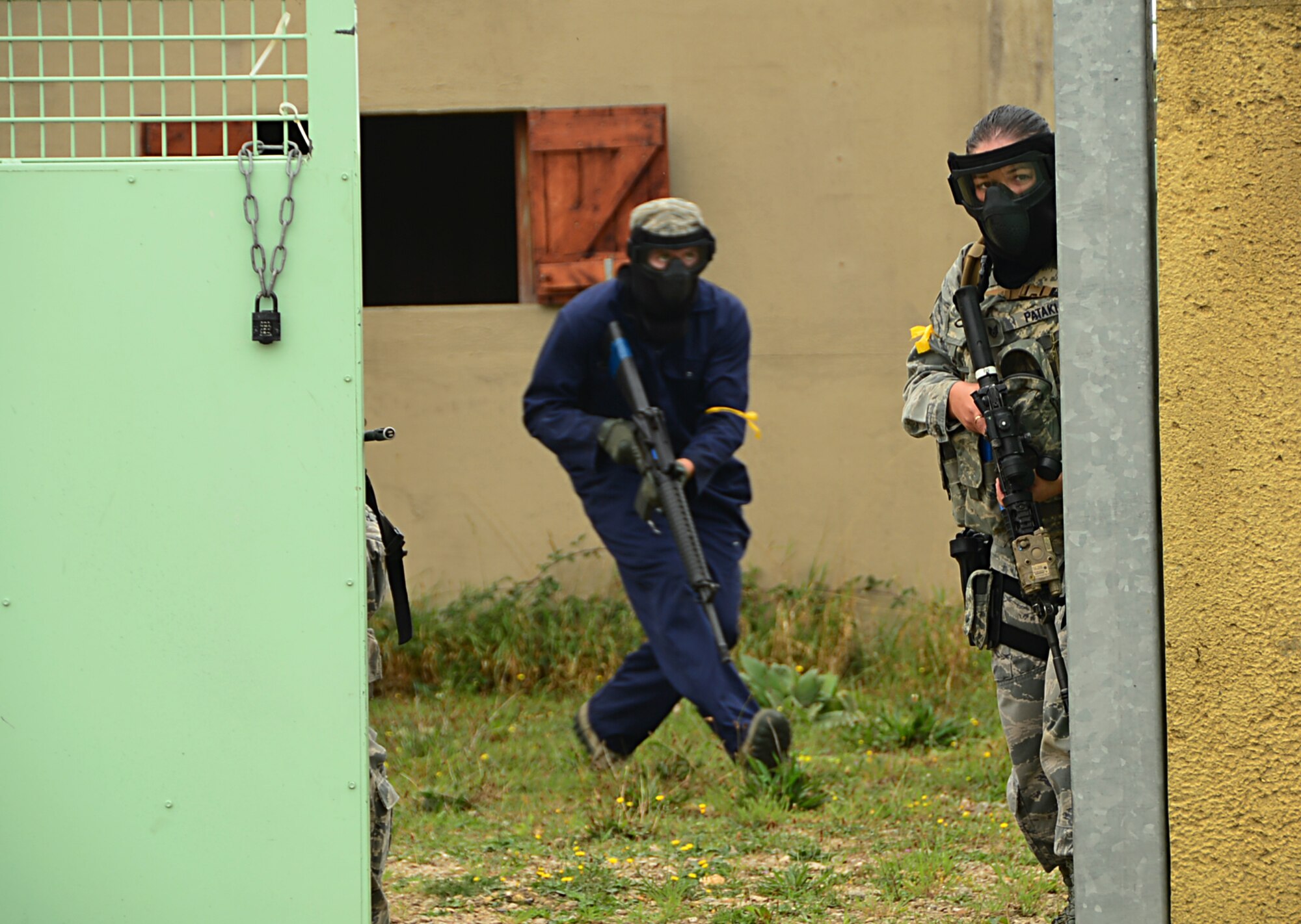 Airmen from the 48th Mission Support Group prepare to cross the street of a mock village during a force-on-force exercise at Stanford Training Area, England, Sept. 19, 2014. The Airmen practiced different scenarios they might encounter on a deployment and familiarized themselves with the M16 and M4 rifles and the M9 pistol. (U.S. Air Force photo by Airman 1st Class Erin O’Shea/Released)   