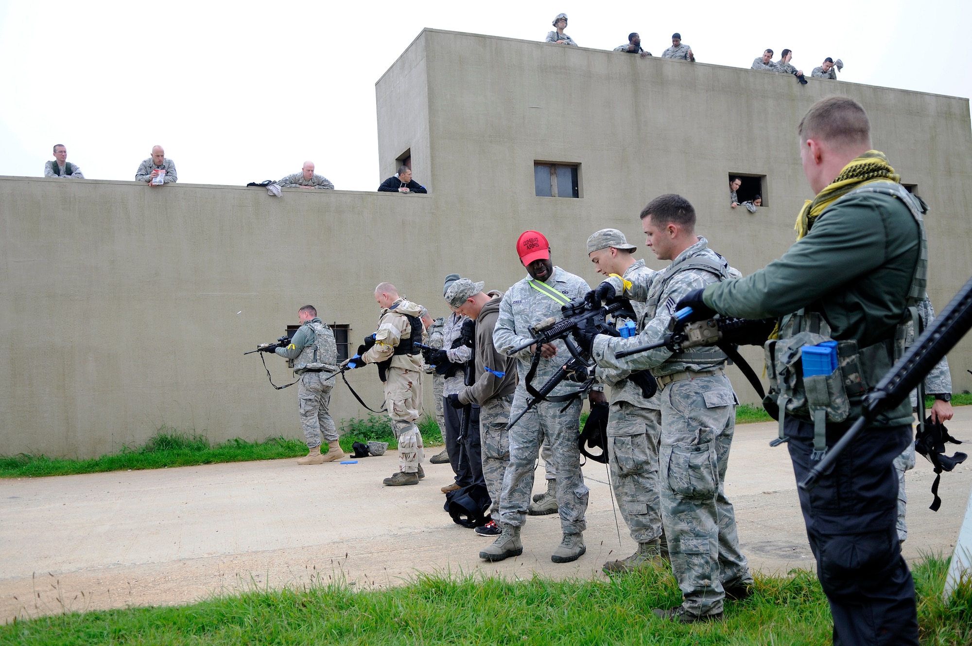 Members of the 48th Mission Support Group clear their weapons after a round of capture the flag during a force-on-force exercise at the Stanford Training Area in Norfolk, England, Sept. 19, 2014. The three-day training included small unit tactics training with Airmen familiarize them with the M16 and M4 rifles and the M9 pistol. (U.S. Air Force photo by Staff Sgt. Emerson Nuñez/Released)