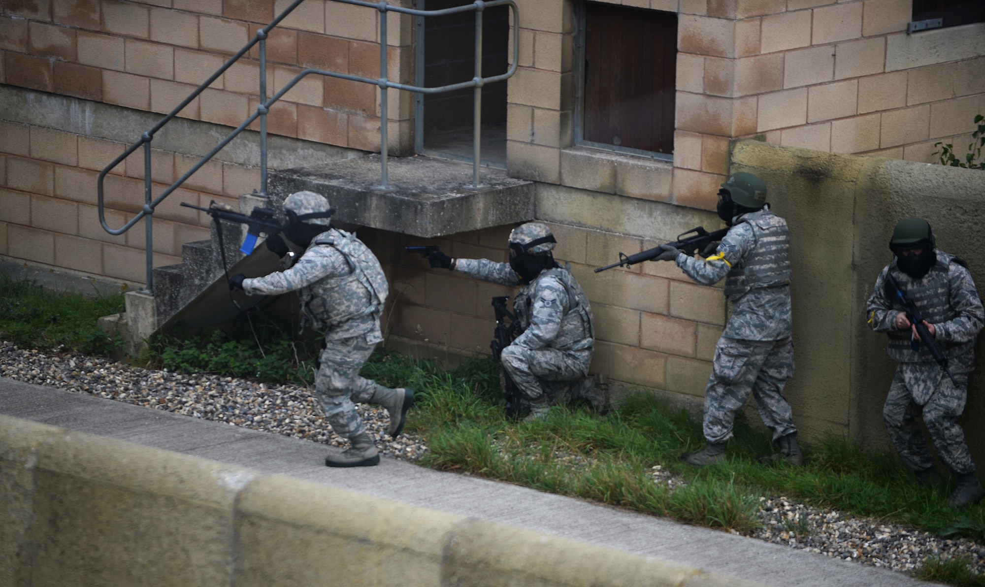 Members of the 48th Mission Support Group fight their way through opposition forces during a force-on-force exercise at the Stanford Training Area in Norfolk, England, Sept. 19, 2014. The main goals of the training were to build team morale and cohesiveness between the different MSG units and give Airmen hands on experience in a deployed environment. (U.S. Air Force photo by Staff Sgt. Emerson Nuñez/Released)