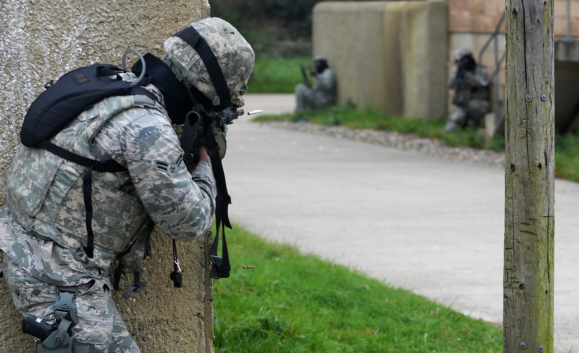 A member of the 48th Security Forces Squadron fires his M4 assault rifle at opposition forces during a force-on-force exercise at the Stanford Training Area in Norfolk, England, Sept. 19, 2014. The three-day event consisted of training similar to Combat Skills Training. (U.S. Air Force photo by Staff Sgt. Emerson Nuñez/Released)