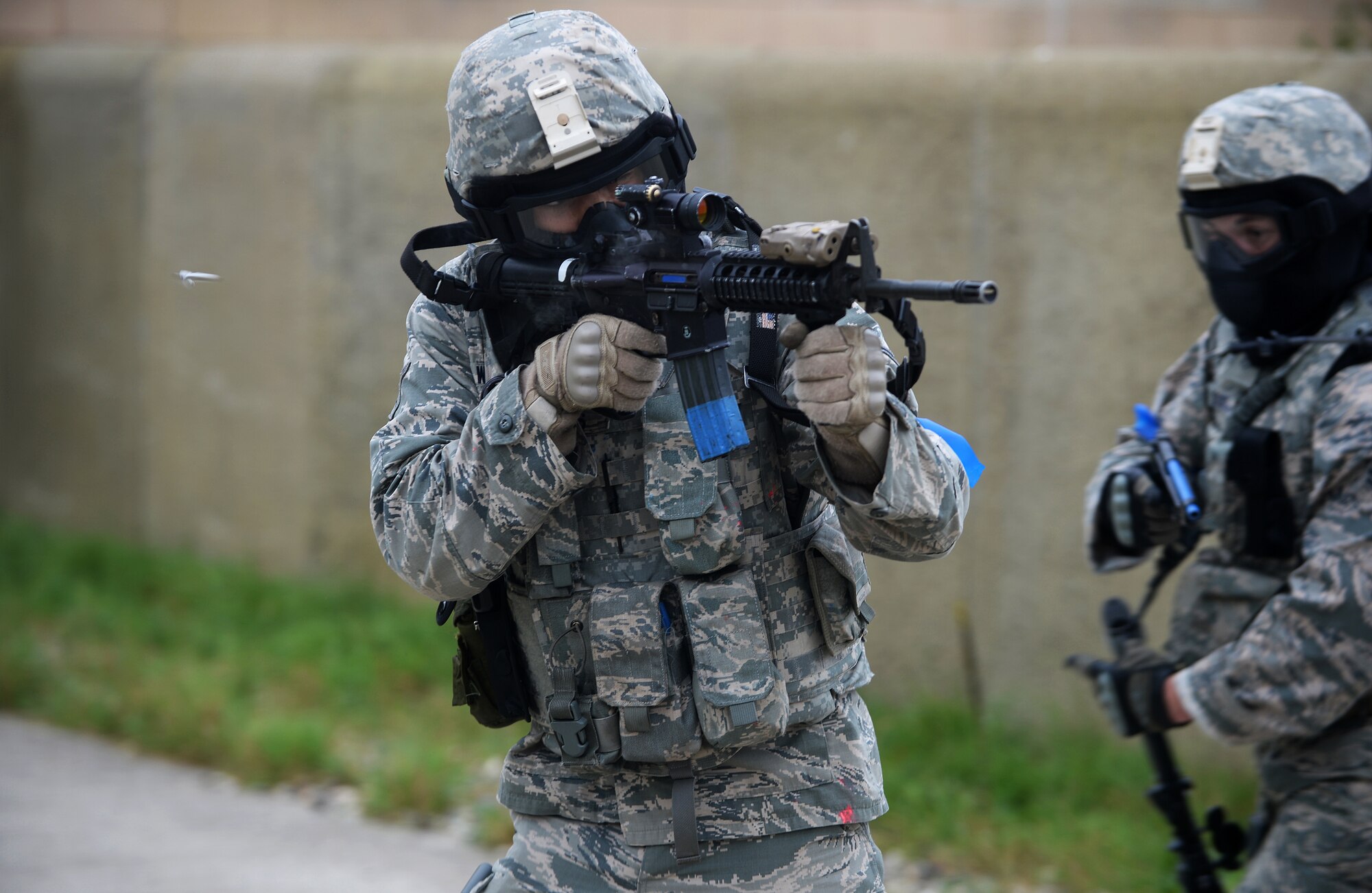 A member of the 48th Security Forces Squadron fires his M4 assault rifle during a force-on-force exercise at the Stanford Training Area in Norfolk, England, Sept. 19, 2014. The three-day training included small unit tactics training with Airmen to familiarize them with the M16 and M4 rifles and the M9 pistol. (U.S. Air Force photo by Staff Sgt. Emerson Nuñez/Released)