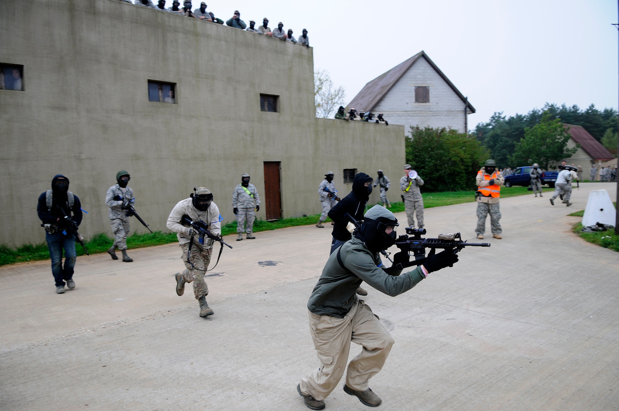 Members of the 48th Mission Support Group sprint to gain tactical positions at the start of a round of capture the flag during a force-on-force exercise at the Stanford Training Area in Norfolk, England, Sept. 19, 2014. The three-day training included Airmen convoying out to the site and bedding down in a mock village. (U.S. Air Force photo by Staff Sgt. Emerson Nuñez/Released)