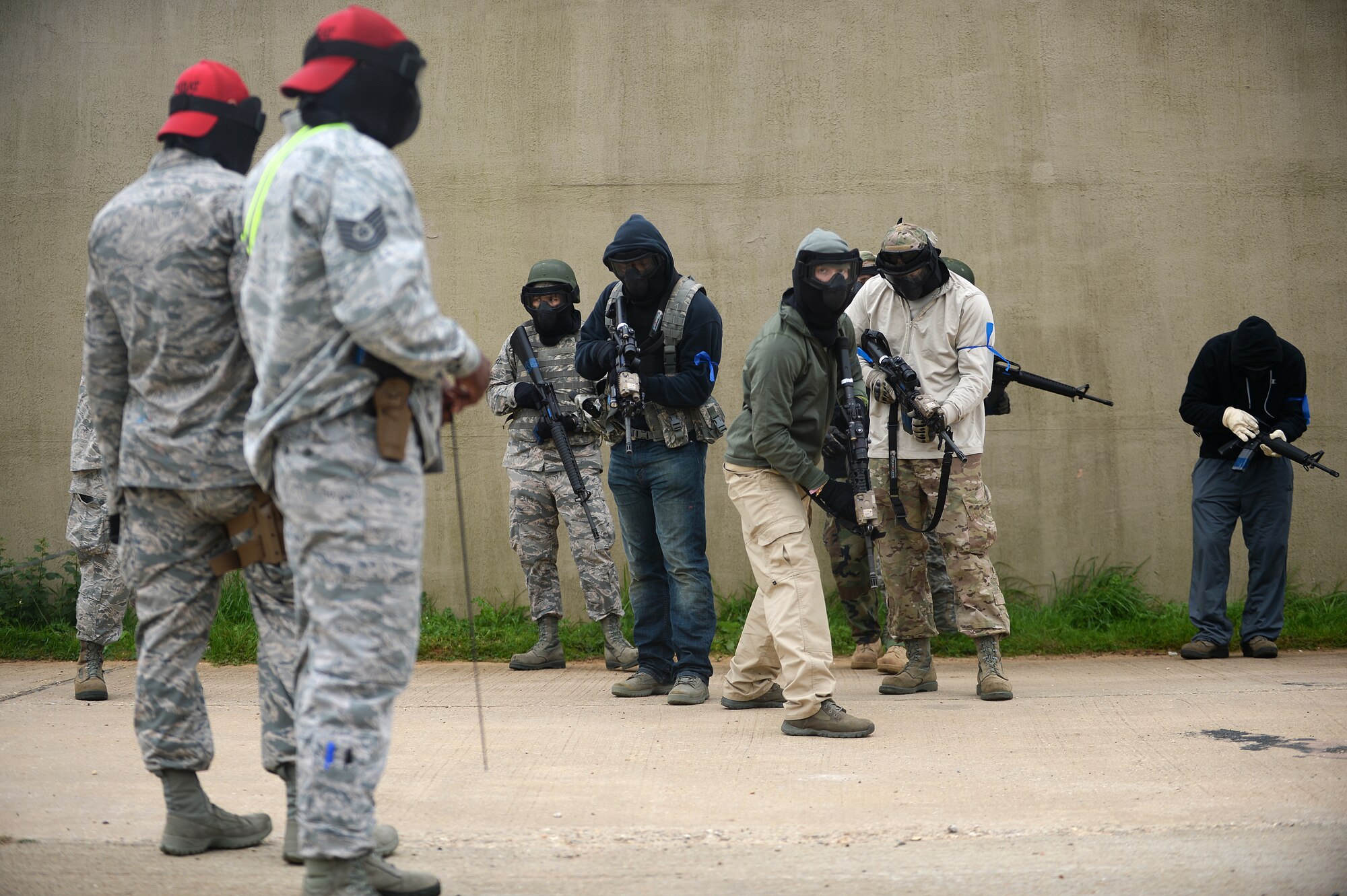 Members of the 48th Mission Support Group prepare for a round of capture the flag as 48th Security Forces Squadron Combat Arms Training and Maintenance instructors oversee weapons safety during a force-on-force exercise at the Stanford Training Area in Norfolk, England, Sept. 19, 2014. The main goals of the training were to build team morale and cohesiveness between the different MSG units and give Airmen hands-on experience in a deployed environment. (U.S. Air Force photo by Staff Sgt. Emerson Nuñez/Released)