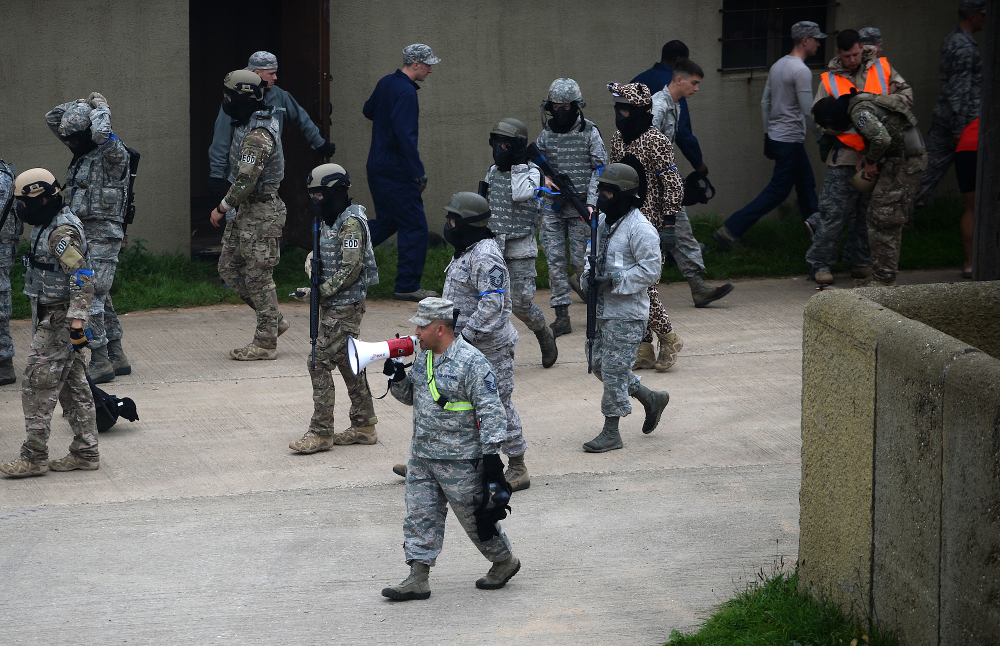 Master Sgt. Albert Verastegui, 48th Security Forces Squadron training superintendent, directs 48th Mission Support Group Airmen during a force-on-force exercise at the Stanford Training Area in Norfolk, England, Sept. 19, 2014. More than 130 Mission Support Group Airmen participated in a three-day field training exercise to gain hands-on experience in a deployed location. (U.S. Air Force photo by Staff Sgt. Emerson Nuñez/Released)