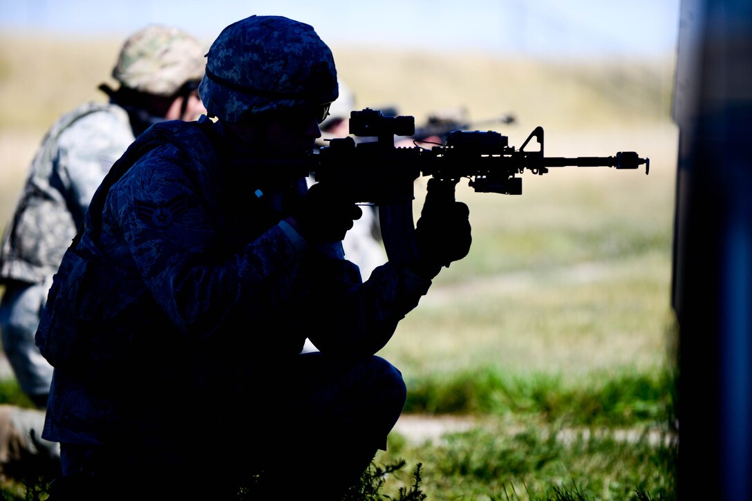 Senior Airman Marcus Miller, 28th Security Forces Squadron patrolman, provides cover in a defense fighting position during small unit tactics training at Ellsworth Air Force Base, S.D., Sept. 12, 2014 during an Operational Readiness Exercise. Defense fighting position provides frontline perimeter security with interlocking fields to protect resources from all directions a vital element of small unit tactics. (U.S. Air Force photo by Senior Airman Zachary Hada/Released)