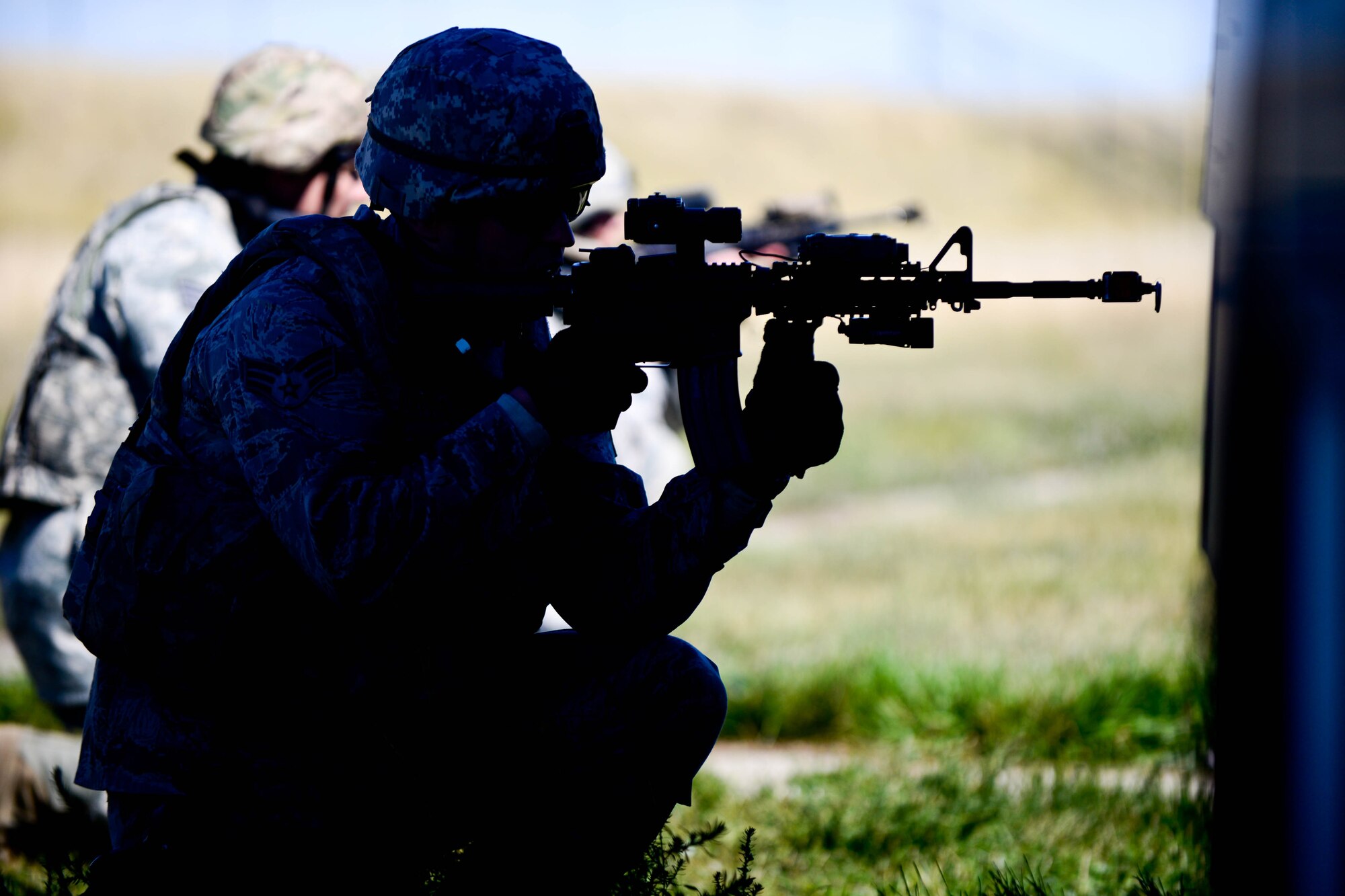 Senior Airman Marcus Miller, 28th Security Forces Squadron patrolman, provides cover in a defense fighting position during small unit tactics training at Ellsworth Air Force Base, S.D., Sept. 12, 2014 during an Operational Readiness Exercise. Defense fighting position provides frontline perimeter security with interlocking fields to protect resources from all directions a vital element of small unit tactics. (U.S. Air Force photo by Senior Airman Zachary Hada/Released)