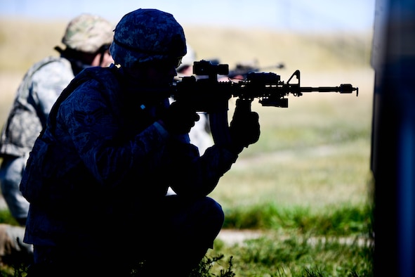 Senior Airman Marcus Miller, 28th Security Forces Squadron patrolman, provides cover in a defense fighting position during small unit tactics training at Ellsworth Air Force Base, S.D., Sept. 12, 2014 during an Operational Readiness Exercise. Defense fighting position provides frontline perimeter security with interlocking fields to protect resources from all directions - a vital element of small unit tactics. (U.S. Air Force photo by Senior Airman Zachary Hada/Released) 
