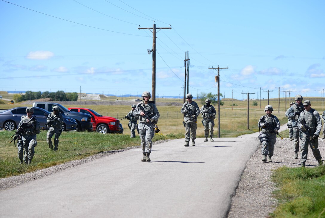 Airmen assigned to the 28th Security Forces Squadron patrol a simulated perimeter during small unit tactics training at Ellsworth Air Force Base, S.D., Sept. 12, 2014 during an Operational Readiness Exercise. OREs are designed to help Airmen hone their skills in preparation of any real world contingencies Airmen may face.  (U.S. Air Force photo by Senior Airman Zachary Hada/Released)
