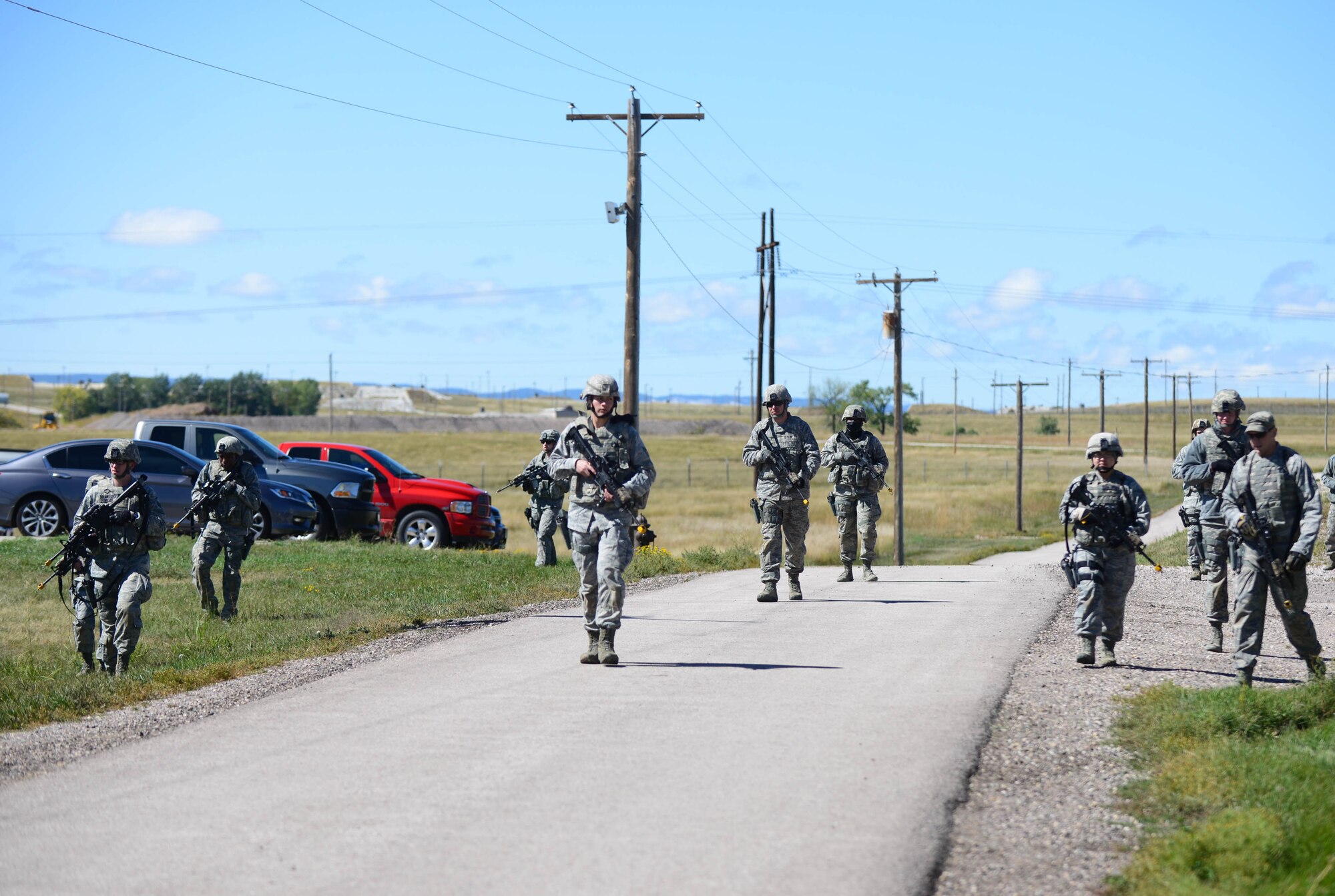Airmen assigned to the 28th Security Forces Squadron patrol a simulated perimeter during small unit tactics training at Ellsworth Air Force Base, S.D., Sept. 12, 2014 during an Operational Readiness Exercise. OREs are designed to help Airmen hone their skills in preparation of any real world contingencies Airmen may face.  (U.S. Air Force photo by Senior Airman Zachary Hada/Released)