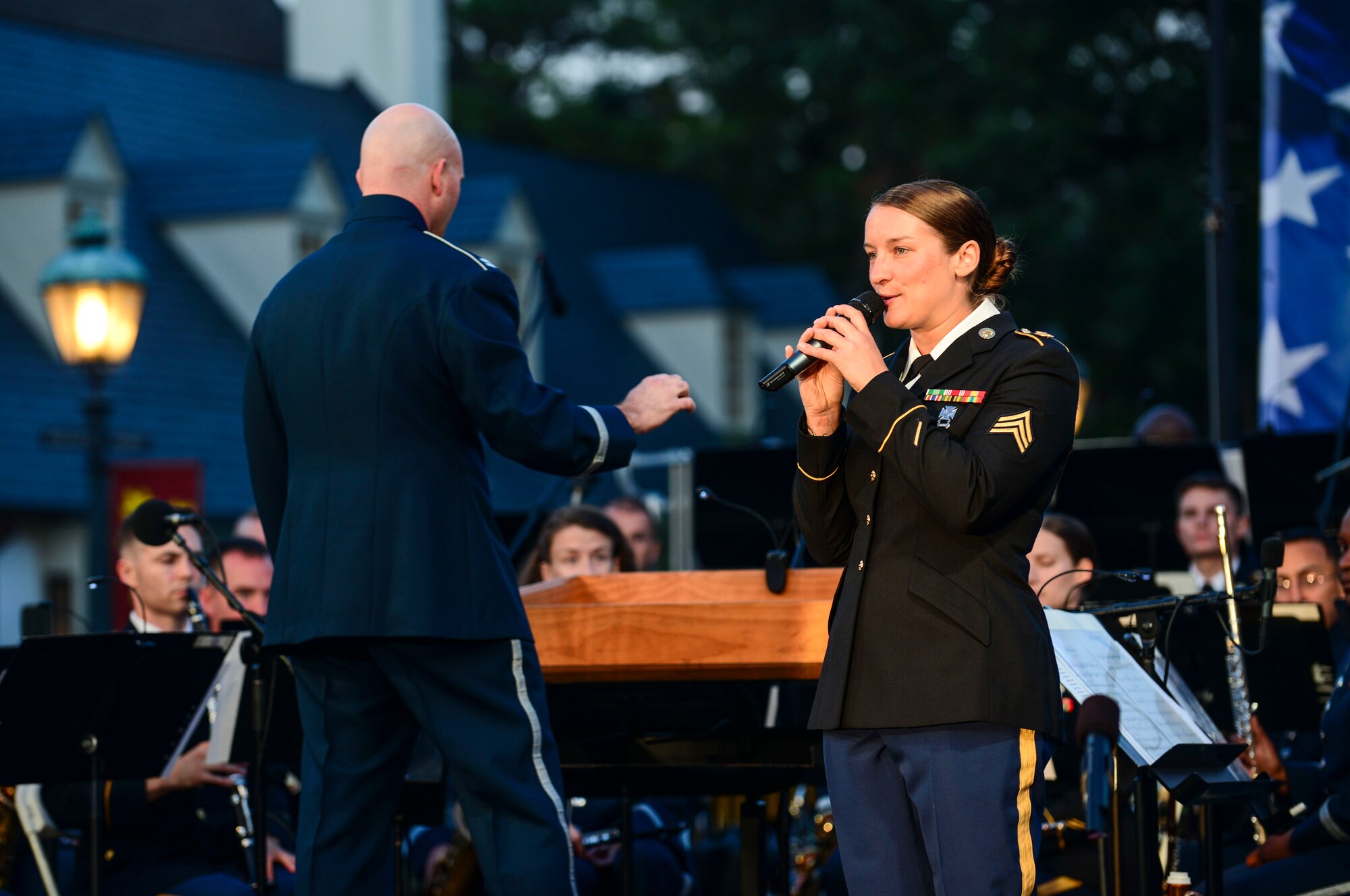 U.S. Army Sgt. Megan Van Oudenaren, Training and Doctrine Command Band vocalist, sings during the Constitution Day “Support and Defend” concert in Williamsburg, Va., Sept 17, 2014. Van Oudenaren sang as the U.S. Air Force Heritage of America and U.S. Army TRADOC bands performed classic military tunes behind her. (U.S. Air Force photo by Airman 1st Class Kimberly Nagle/Released)