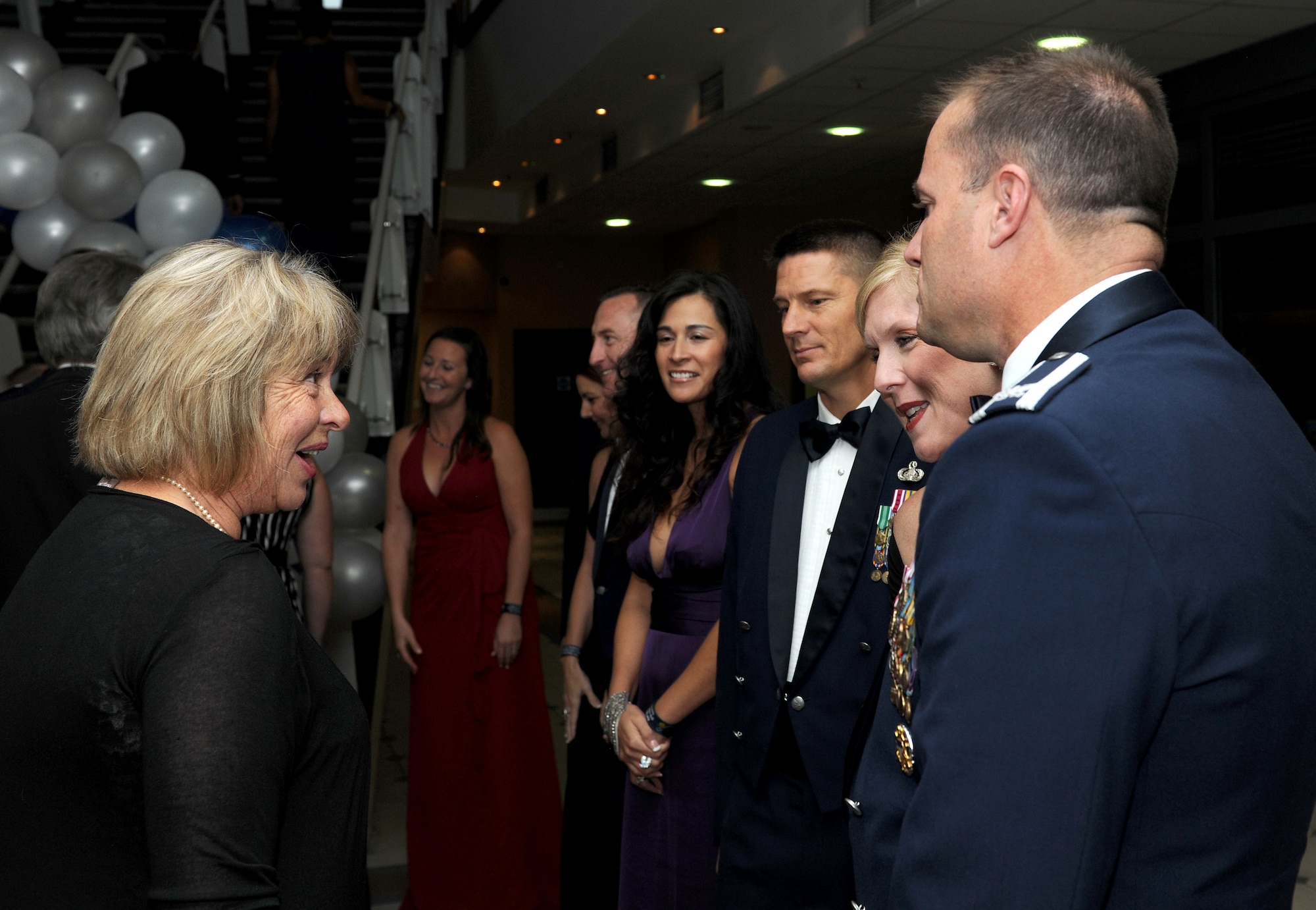 Team Mildenhall leaders greet guests as they enter the Air Force Ball Sept. 20, 2014, on RAF Mildenhall, England. Over 400 guests attended the event in celebration of the Air Force’s 67th birthday as an independent service. The theme for the event was “Professional Warfighter: Core Values, Keys to Enduring Success.” (U.S. Air Force photo/Senior Airman Kate Maurer/Released) 