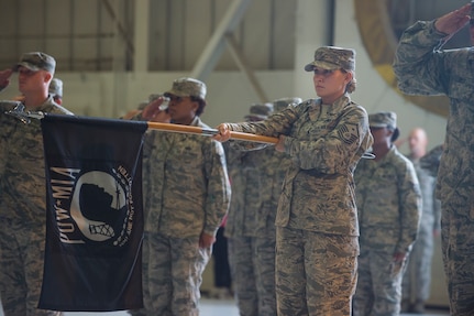 Master Sgt. Angela Bergerstock, 1st Combat Camera Squadron first sergeant, holds the POW/MIA flag during the retreat ceremony Sept. 19, 2014, at Joint Base Charleston, S.C. Every year, the nation honors former POWs and service members still missing in action during POW/Mia Recognition Day. (U.S. Air Force photo/Senior Airman George Goslin)