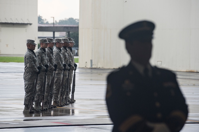 The Joint Base Charleston honor guard stands in formation while the rains come down during the POW/MIA Retreat Ceremony Sept. 19, 2014, at Joint Base Charleston, S.C. Every year, the nation honors itsPOWs and service members still listed as missing in action during POW/Mia Recognition Day. (U.S. Air Force photo/Senior Airman George Goslin)