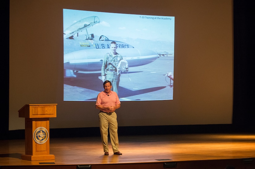 Retired Capt. Chuck Jackson, U.S. Air Force, speaks to Airmen and Sailors about his POW experiences Sept. 18, 2014, at Joint Base Charleston, S.C. Jackson was shot down over Vietnam in 1972 and was captured shortly after. (U.S. Air Force photo/Senior Airman George Goslin)