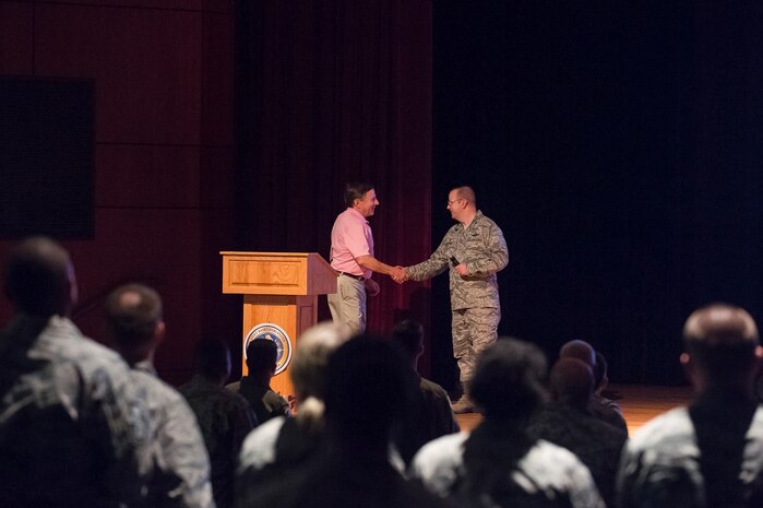 Retired Capt. Chuck Jackson, U.S. Air Force, greets Col. Jeffrey DeVore, Joint Base Charleston commander, before giving a speech Sept. 18, 2014, at Joint Base Charleston, S.C. Jackson was shot down over Vietnam in 1972 and was captured shortly after. (U.S. Air Force photo/Senior Airman George Goslin)