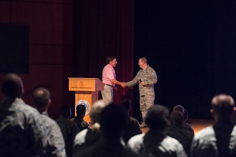 Retired Capt. Chuck Jackson, U.S. Air Force, greets Col. Jeffrey DeVore, Joint Base Charleston commander, before giving a speech Sept. 18, 2014, at Joint Base Charleston, S.C. Jackson was shot down over Vietnam in 1972 and was captured shortly after. (U.S. Air Force photo/Senior Airman George Goslin)