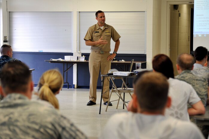 Cmdr. Sean Szymanski, 628th Air Base Wing deputy executive director, leads a wingman day discussion at the Naval Weapons Station Chapel Annex, Sept. 19, 2014, at Joint Base Charleston, S.C. Szymanski assisted planning, coordinating and hosting this year's wingman day for the 628th ABW Wing Staff Agency which included team building exercises, discussion on the traits of a good wingman and a review of the service’s core values. (U.S. Air Force photo/Staff Sgt. Renae Pittman)