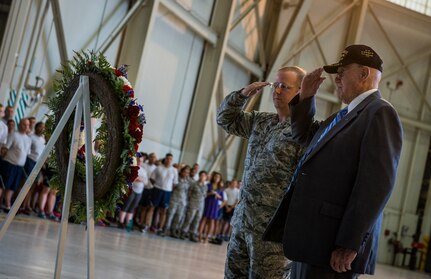 Col. Jeffrey DeVore, Joint Base Charleston commander, and former Prisoner of War, salute a Prisoner of War, Missing in Action wreath during a retreat ceremony Sept. 19, 2014, at Joint Base Charleston, S.C. The ceremony was held in honor of prisoners of war, service members still missing in action and family members who share in the sacrifices of freedom. (U.S. Air Force photo/ Senior Airman Dennis Sloan)