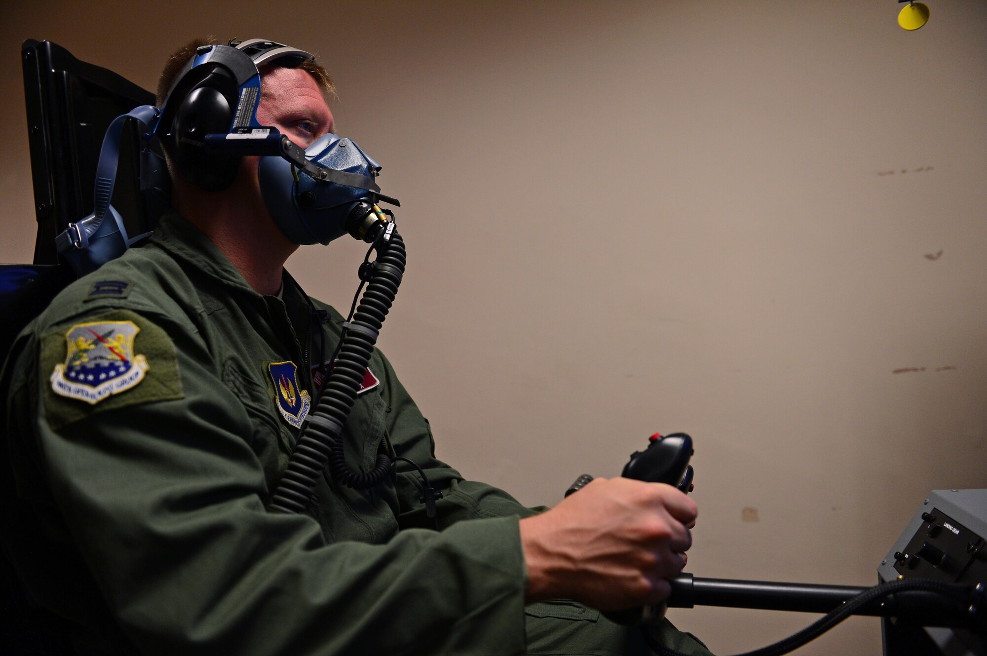 Capt. David Cox, 100th Operations Group training assistant chief, flies an aircraft simulator during simulated hypoxia training at Royal Air Force Lakenheath, England, Sept. 17, 2014. Every five years, aircrew are required to undergo hypoxia familiarization training to reintroduce them to signs and symptoms of hypoxia. (U.S. Air Force photo by Airman 1st Class Erin O’Shea/Released)