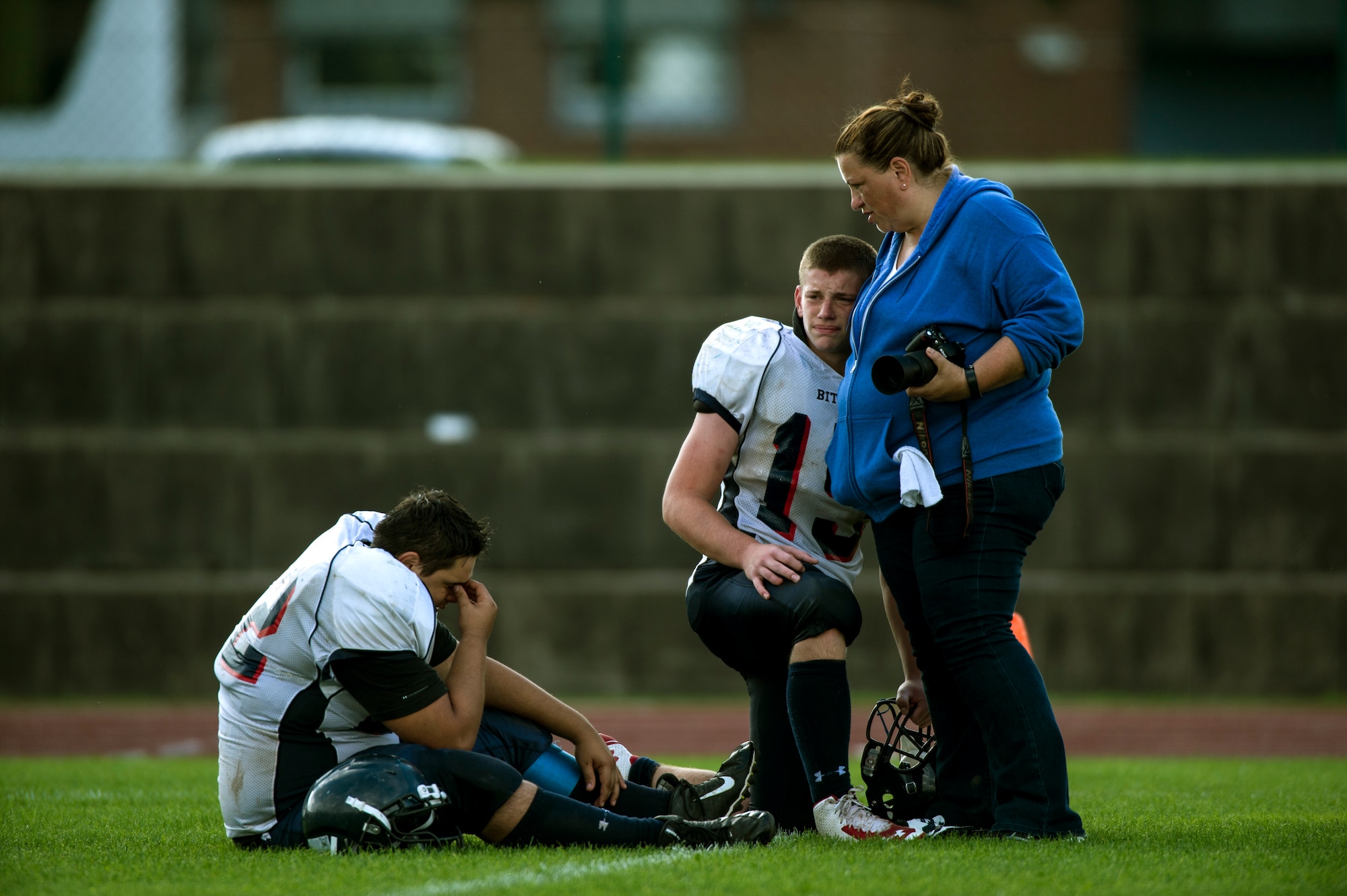 Anita Laue, wife of Bitburg Barons football team head coach Mike Laue, comforts players after they lost their regular season game against the Ansbach Cougars Sept. 20, 2014, at Ansbach, Germany. The loss ended the Barons’ undefeated season. (U.S. Air Force photo by Senior Airman Rusty Frank/Released)