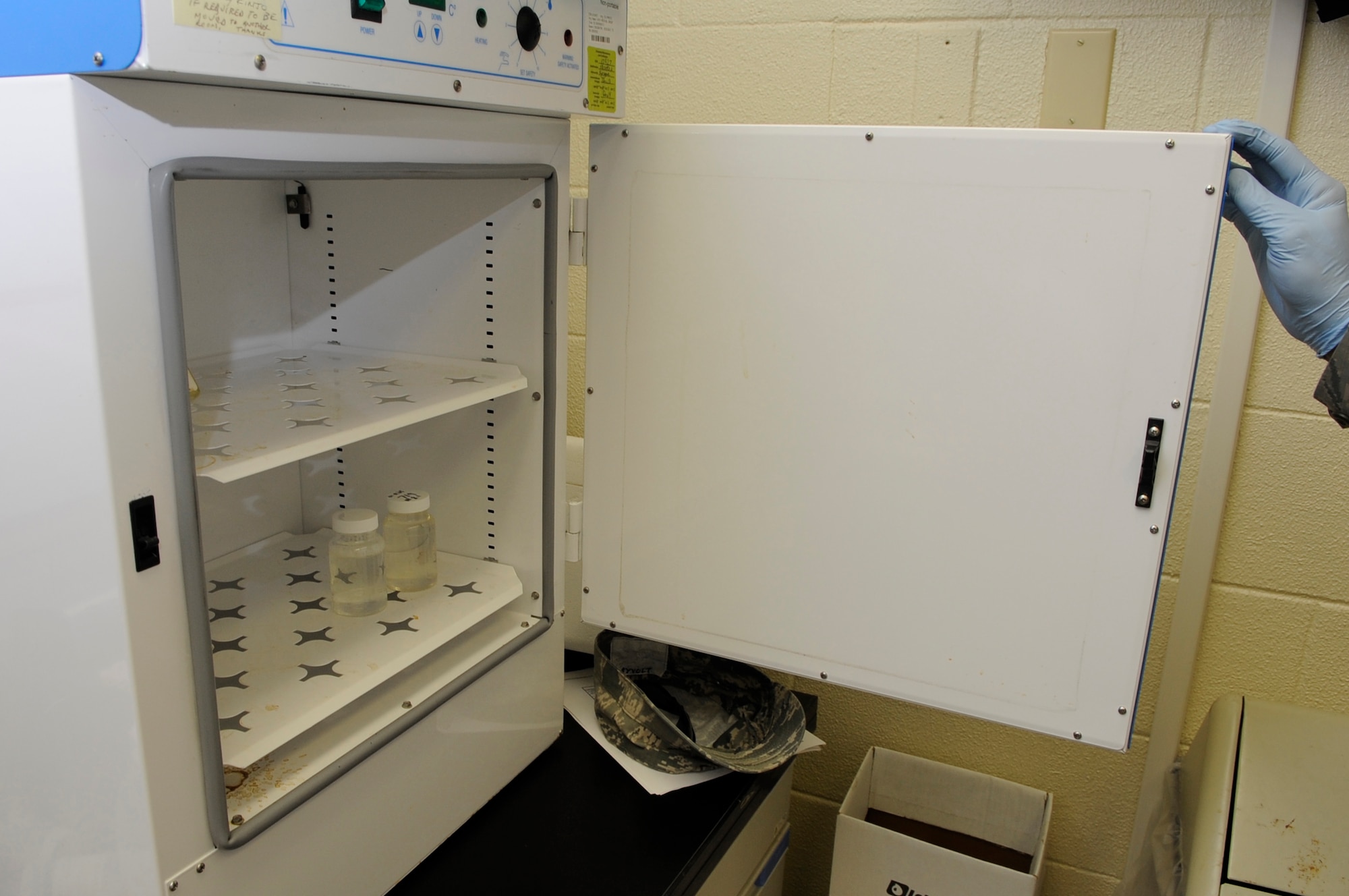 U.S. Air Force Senior Airman Dustin Dayvolt, 18th Aerospace Medicine Squadron bioenvironmental engineering technician, places a test blank and a test sample into an incubator Kadena Air Base, Japan, Sept. 23, 2014. The incubator allows the technicians to check for the presence of E. coli in the water sample. (U.S. Air Force photo by Senior Airman Marcus Morris/Released)

