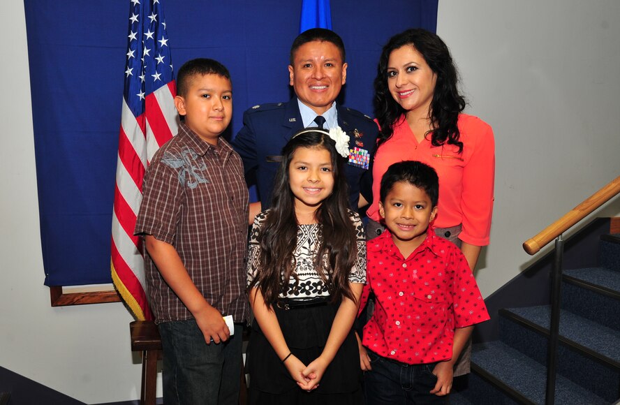 U.S. Air Force Lt. Col. Erick Fonseca, 35th Fighter Wing chief of command post, stands with his family during his promotion ceremony at Misawa Air Base, Japan, Aug. 28, 2014. His humble upbringing in Ecuador helped formulate the great appreciation he has for the United States and the opportunity it has given his family. (U.S. Air Force photo by Senior Airman Jose L. Hernandez-Domitilo/Released)