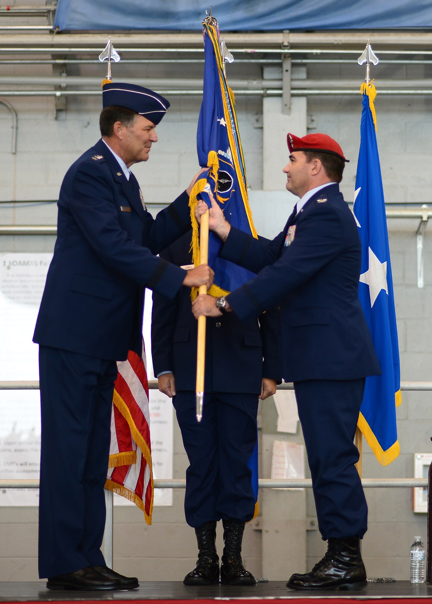 Lt. Gen. Bradley Heithold, Air Force Special Operations Command commander hands the 24th Special Operations Wing guidon to Col. Matthew "Wolfe" Davidson, 24th SOW commander, at the Commando Hangar, Hurlburt Field, Fla., 
Sept. 19, 2014. This is Davidson's fifth command position, and he is responsible for preparing more than 1,500 special tactics Airmen for rapid global employment to enable airpower success. 
